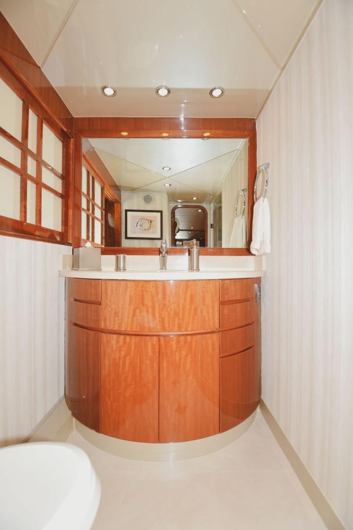 a bathroom with a wooden vanity aboard WARHORSE Yacht for Sale
