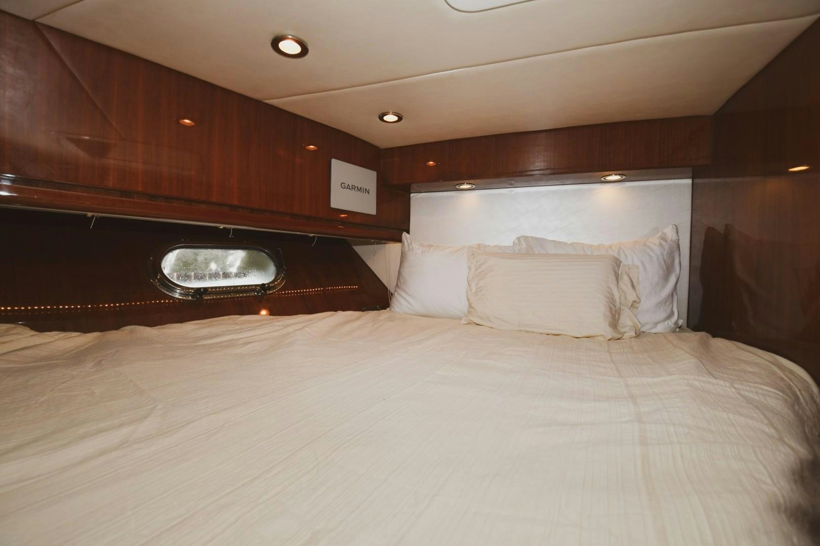 a bed with white sheets aboard WARHORSE Yacht for Sale