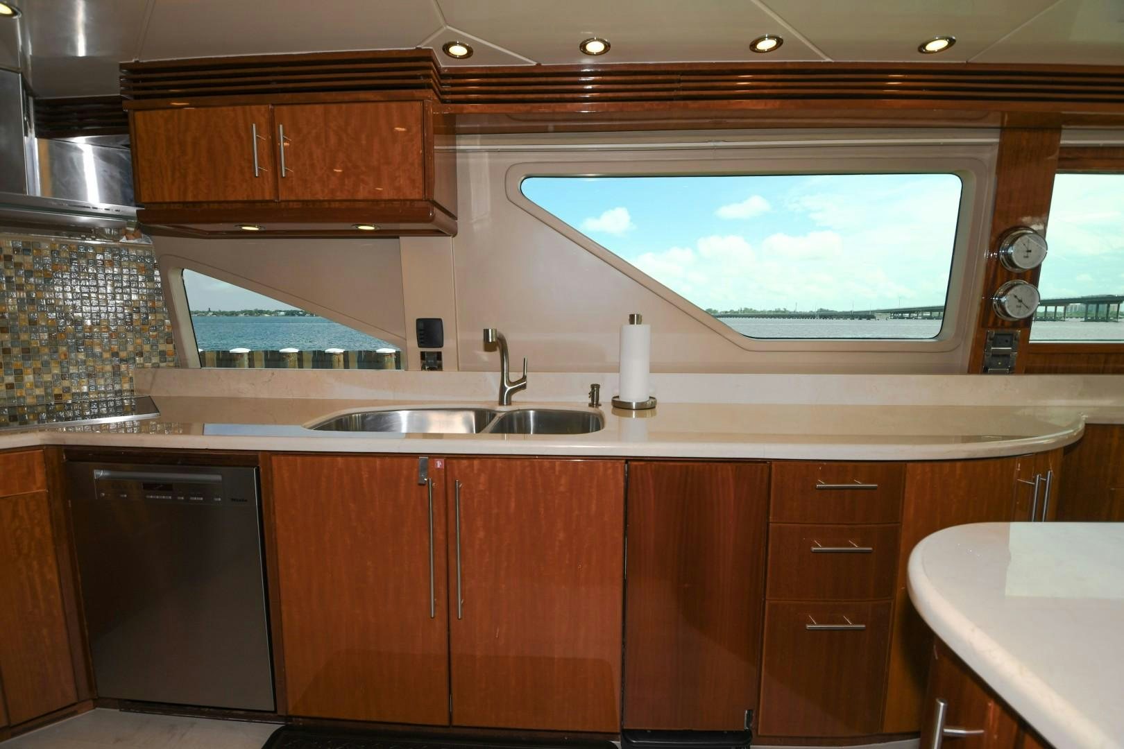 a kitchen with wooden cabinets aboard WARHORSE Yacht for Sale