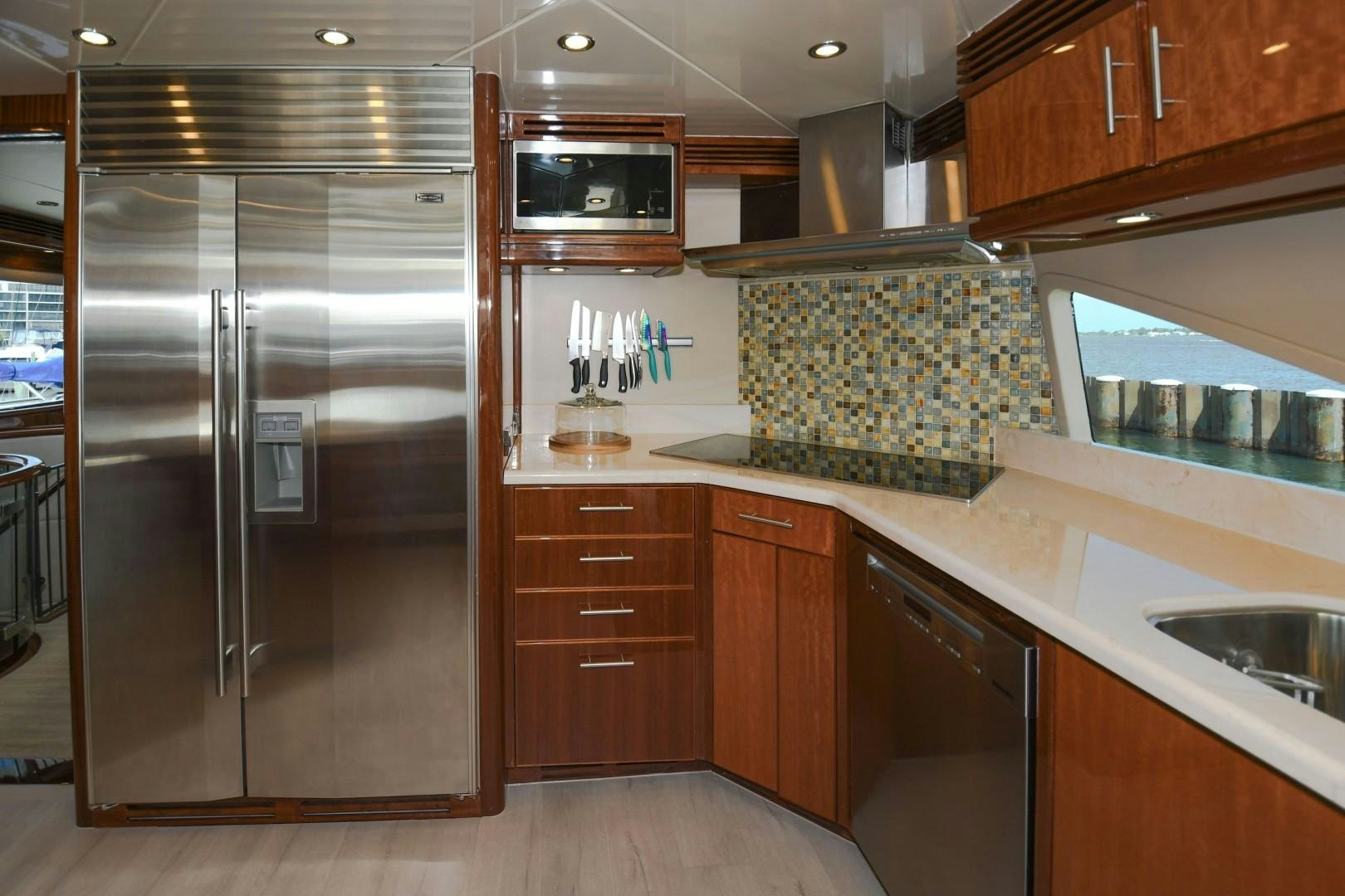a kitchen with a stainless steel refrigerator aboard WARHORSE Yacht for Sale