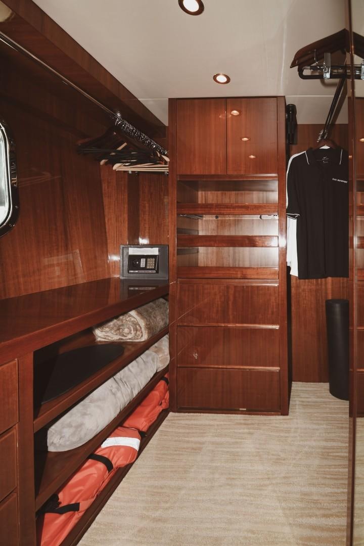a wood cabinet in a room aboard WARHORSE Yacht for Sale