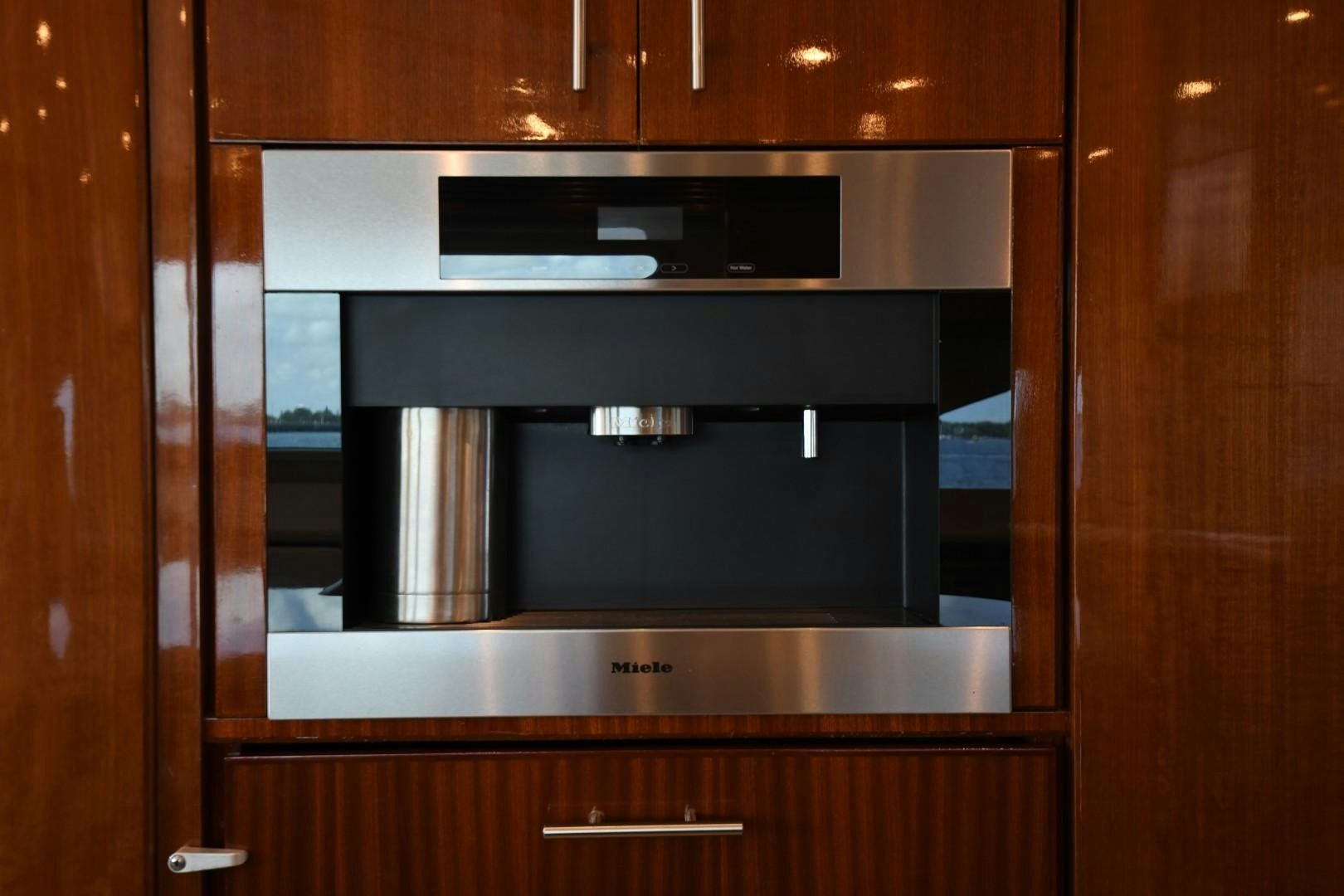 a microwave oven in a wooden cabinet aboard WARHORSE Yacht for Sale