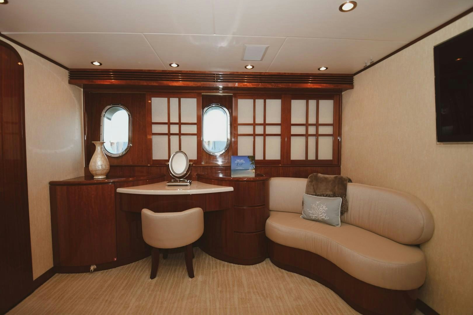 a living room with a couch and a desk aboard WARHORSE Yacht for Sale