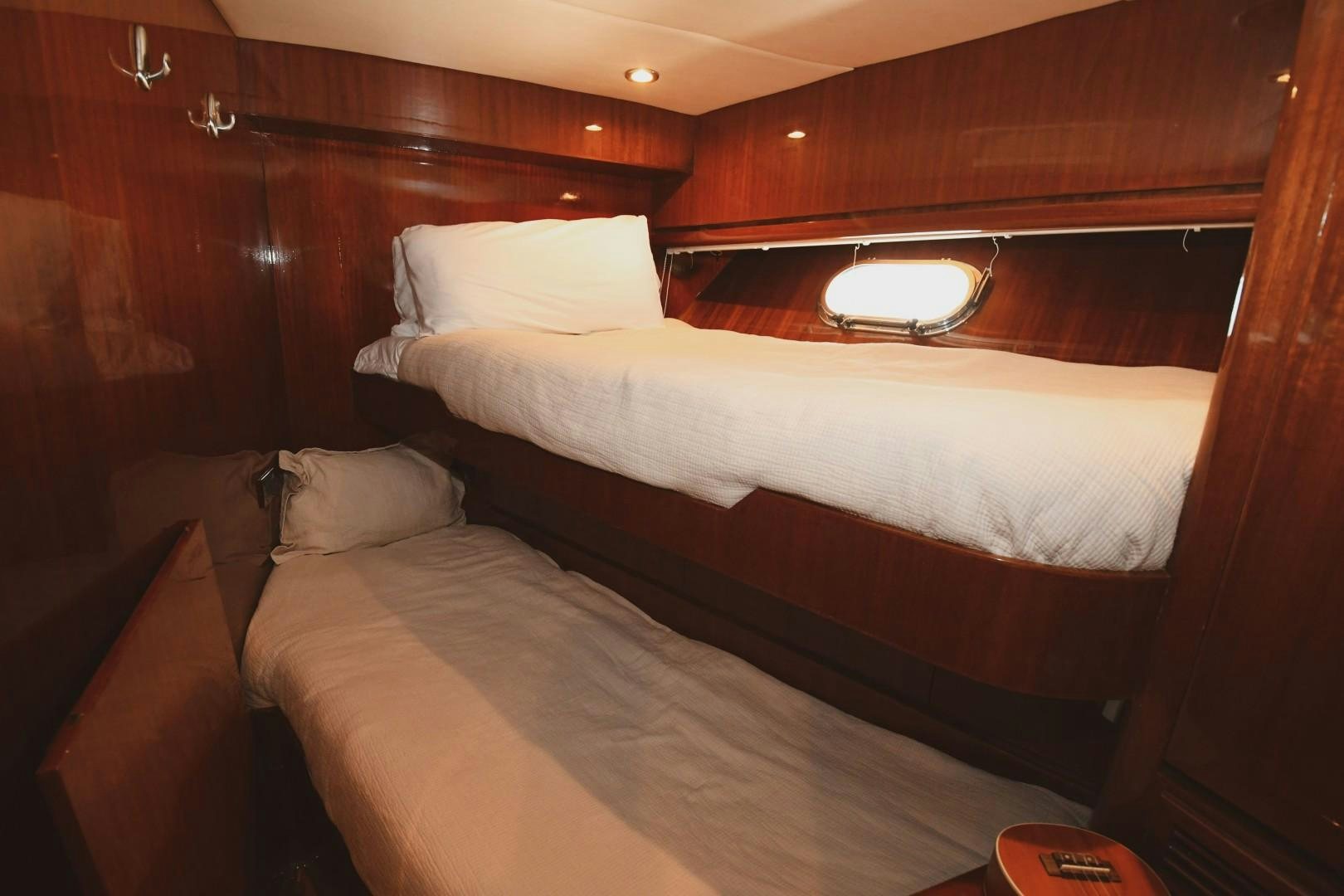 a bed with white sheets aboard WARHORSE Yacht for Sale