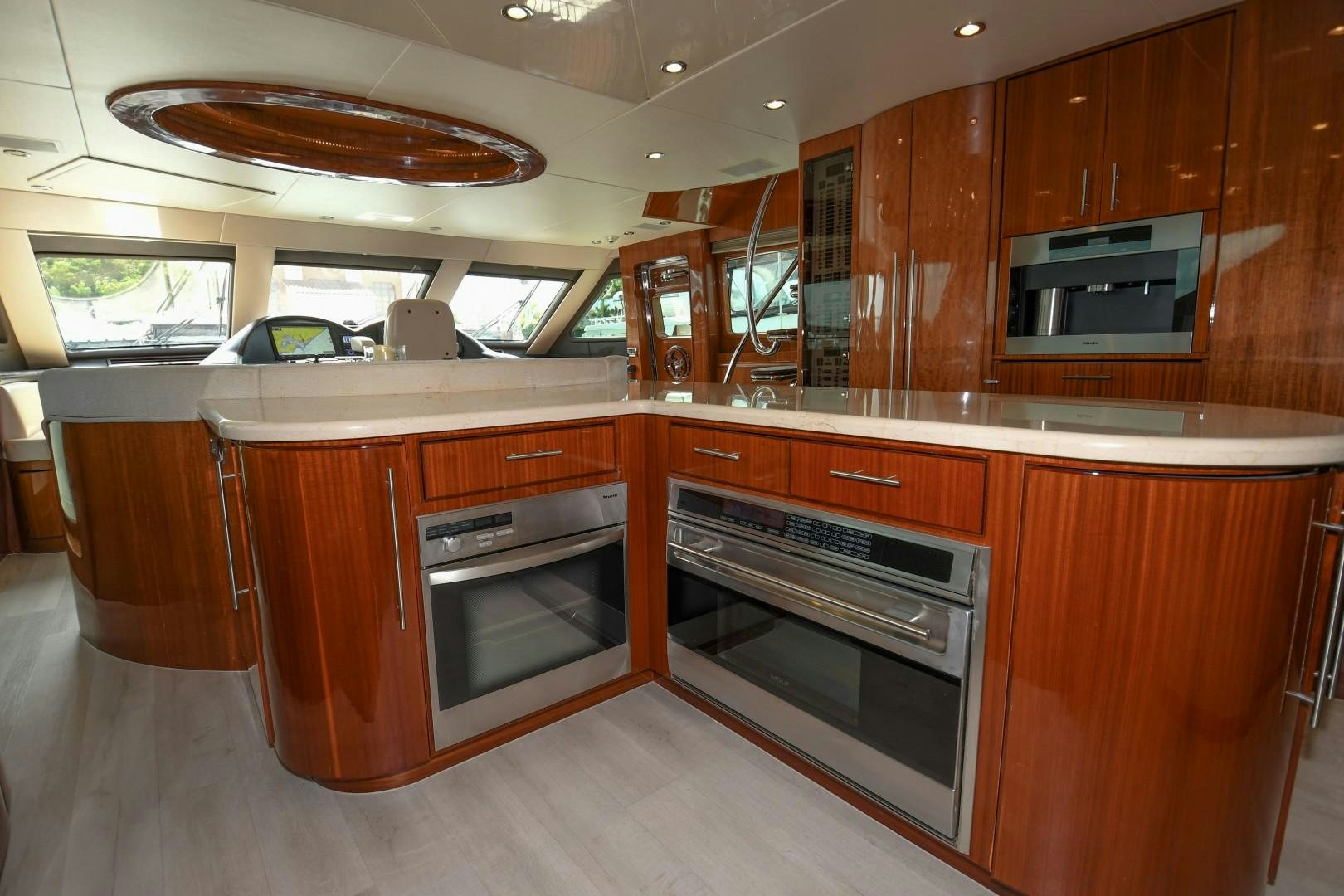 a kitchen with wooden cabinets aboard WARHORSE Yacht for Sale