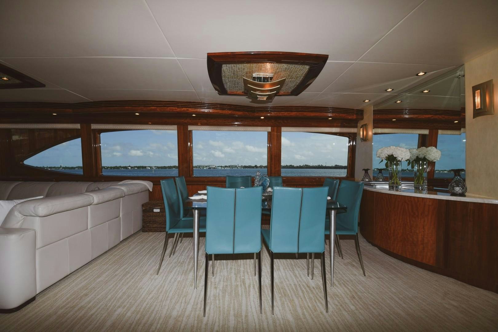 a room with a table and chairs aboard WARHORSE Yacht for Sale