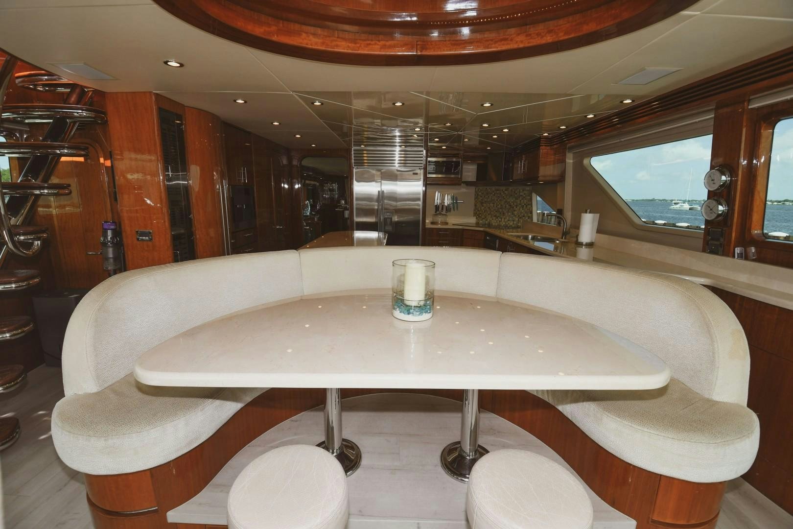 a table with chairs and a window aboard WARHORSE Yacht for Sale