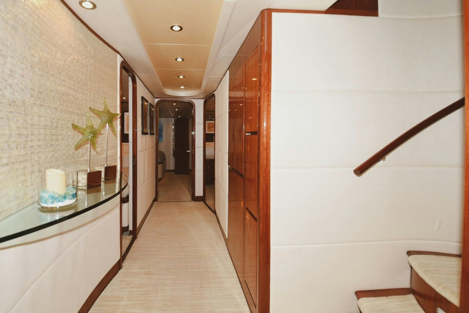 a hallway with a table and chairs aboard WARHORSE Yacht for Sale