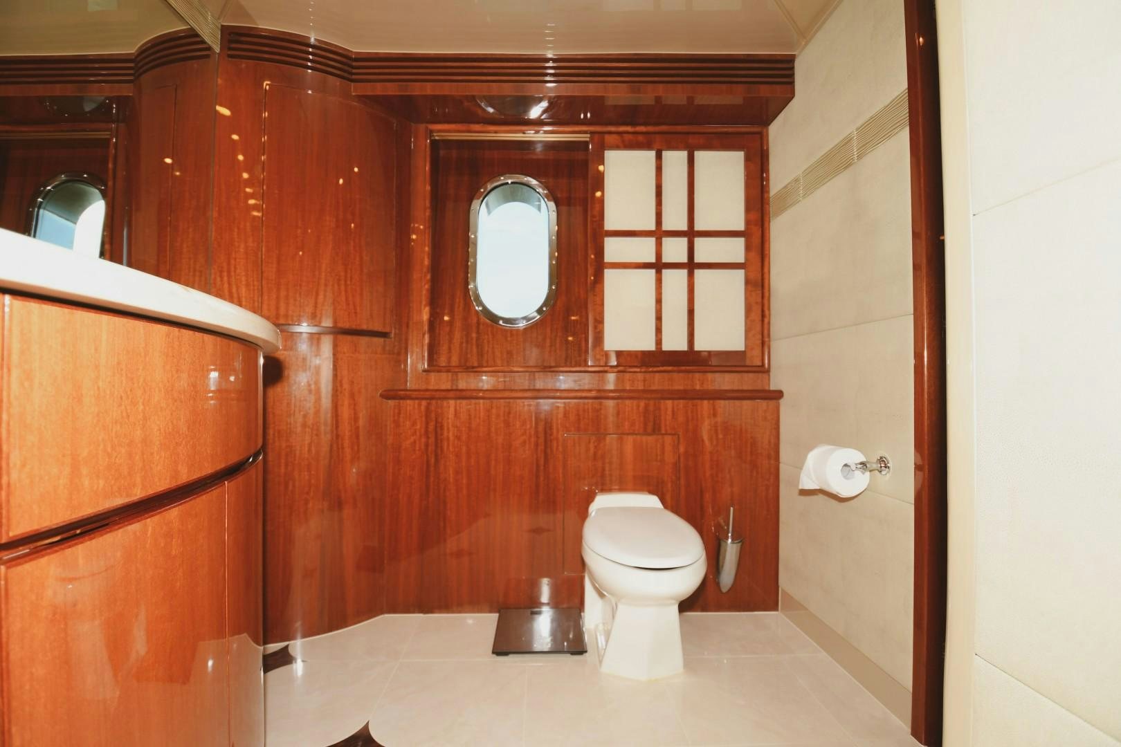 a bathroom with wooden cabinets aboard WARHORSE Yacht for Sale