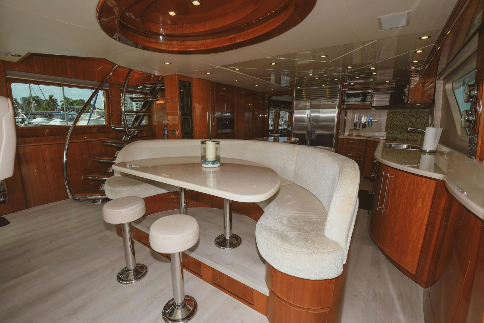 a room with a table and stools aboard WARHORSE Yacht for Sale