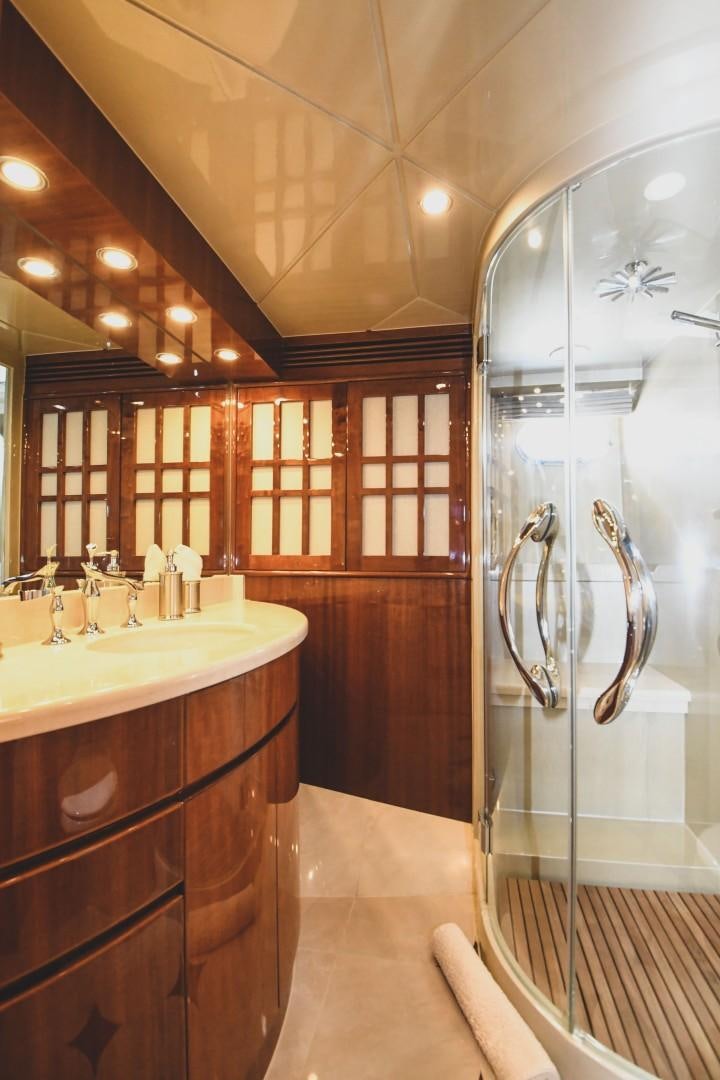 a bathroom with a glass shower aboard WARHORSE Yacht for Sale