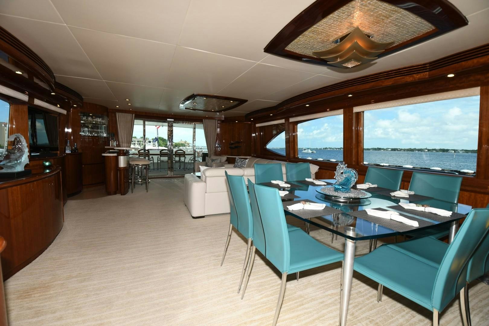 a large room with a table and chairs and a large window aboard WARHORSE Yacht for Sale