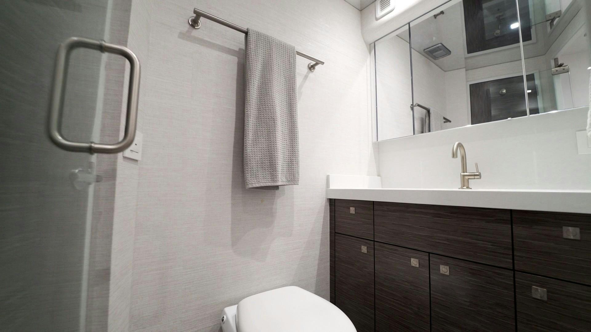 a bathroom with a toilet and a sink aboard Fish Tank Yacht for Sale