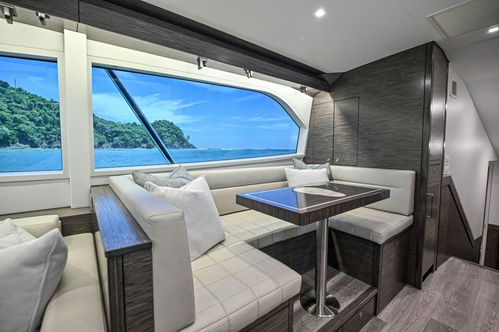 a room with a table and chairs aboard Fish Tank Yacht for Sale