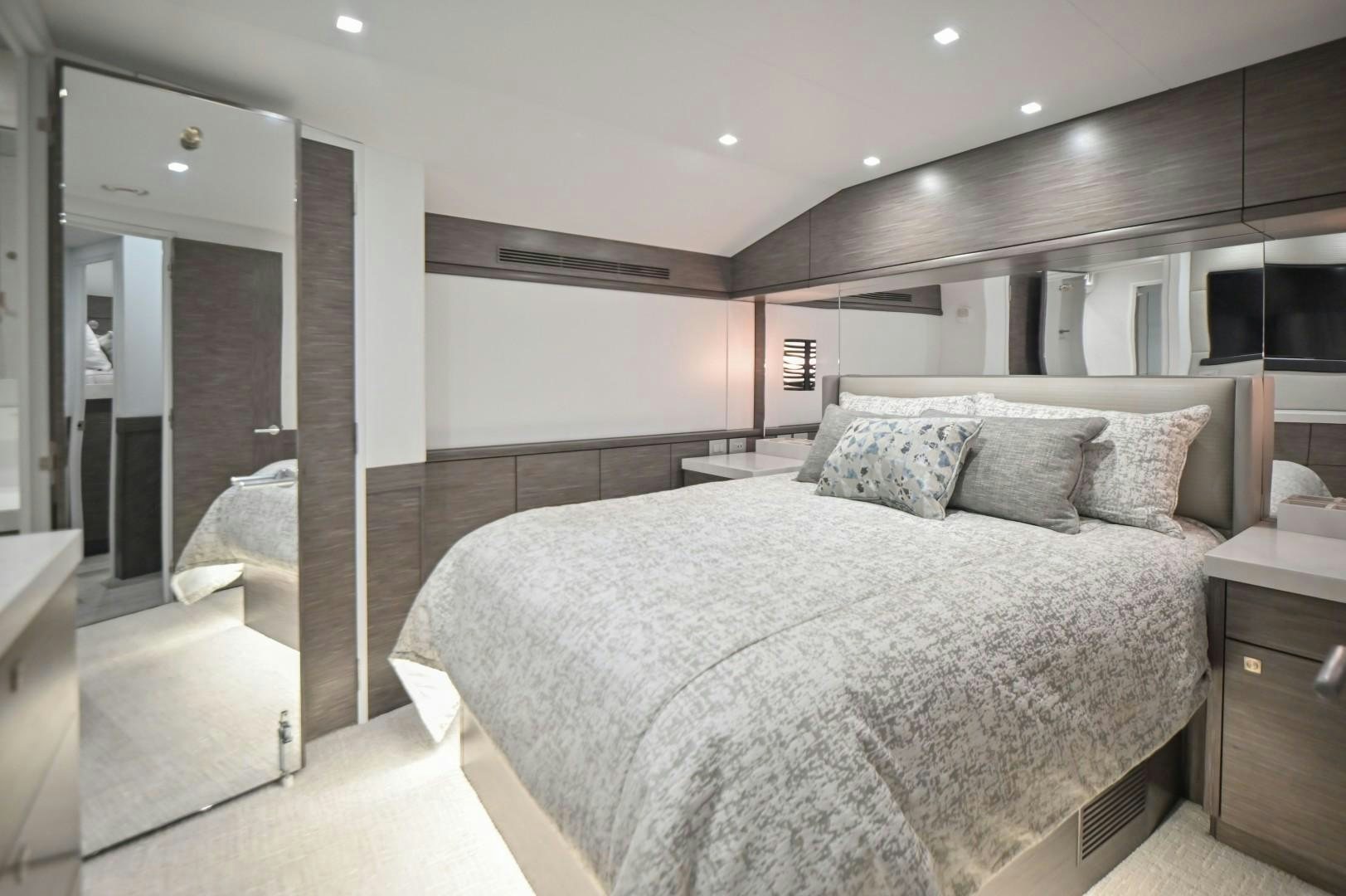 a large bedroom with a large bed aboard Fish Tank Yacht for Sale