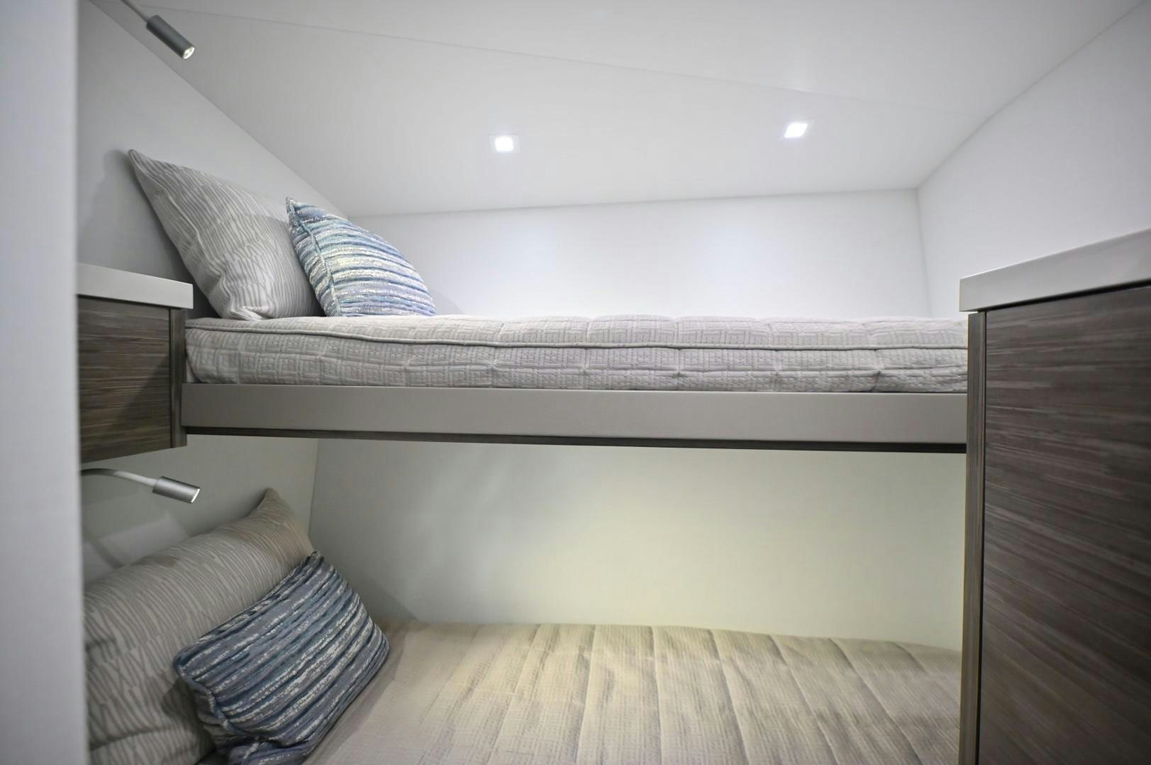 a bed with white sheets aboard Fish Tank Yacht for Sale