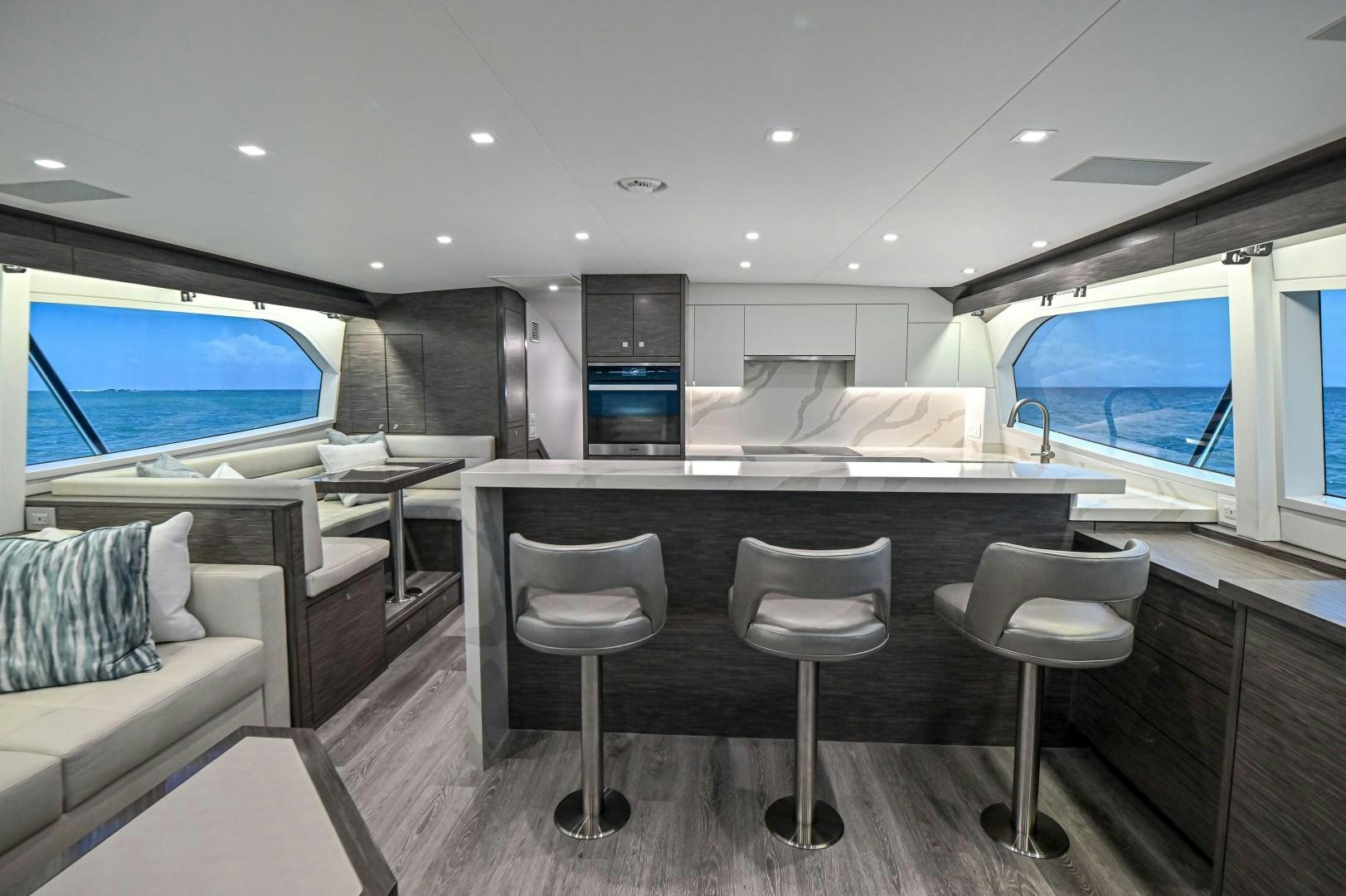 a room with a table chairs and a couch aboard Fish Tank Yacht for Sale