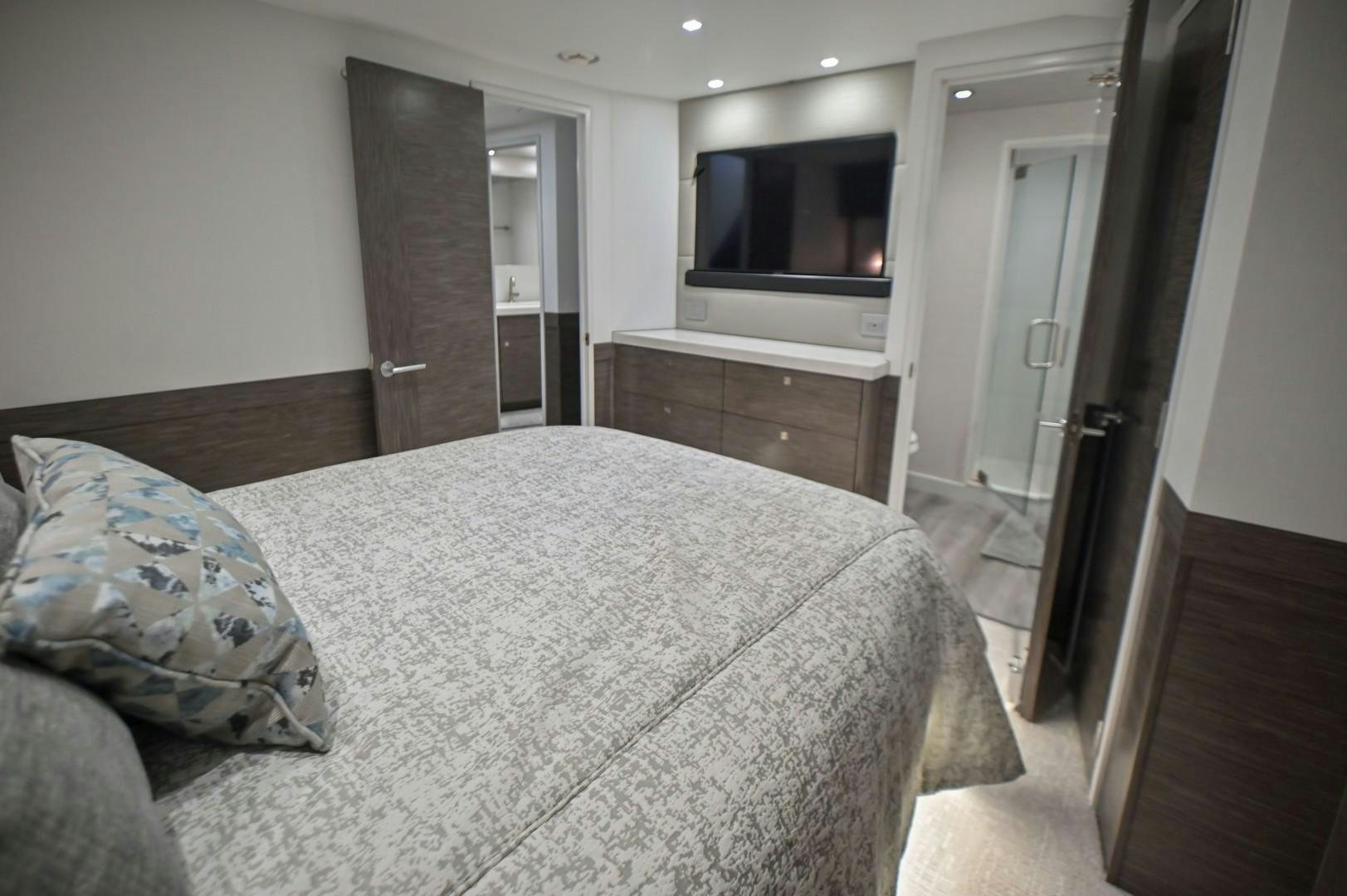 a bedroom with a bed aboard Fish Tank Yacht for Sale