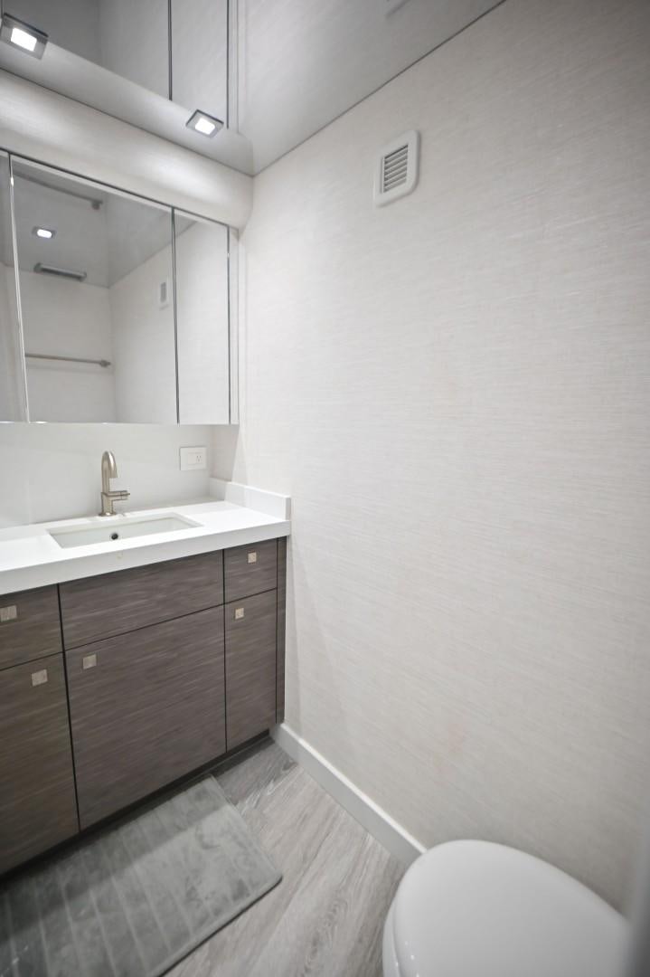 a bathroom with a sink and a toilet aboard Fish Tank Yacht for Sale