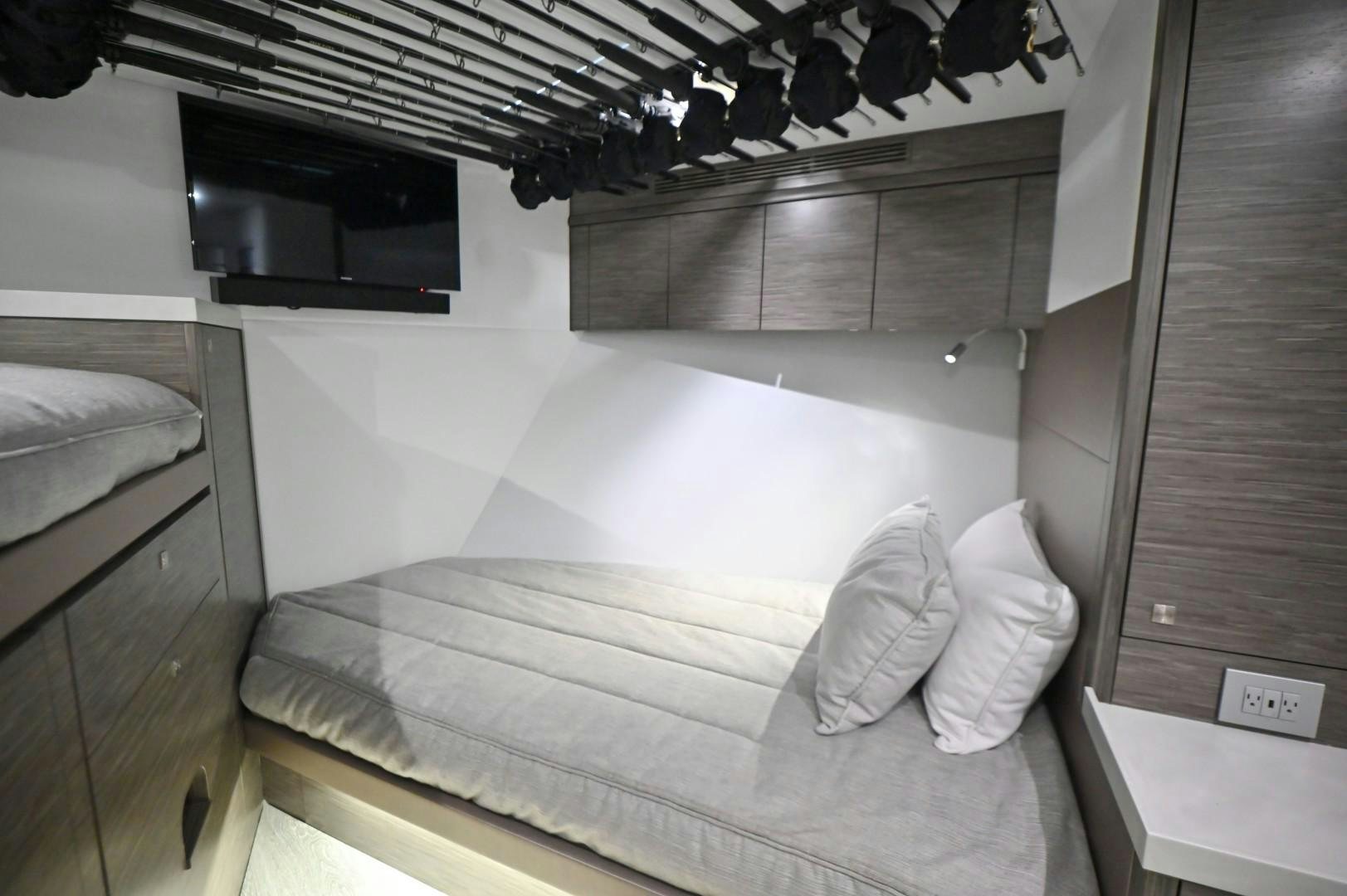 a bedroom with a bed and microwave aboard Fish Tank Yacht for Sale