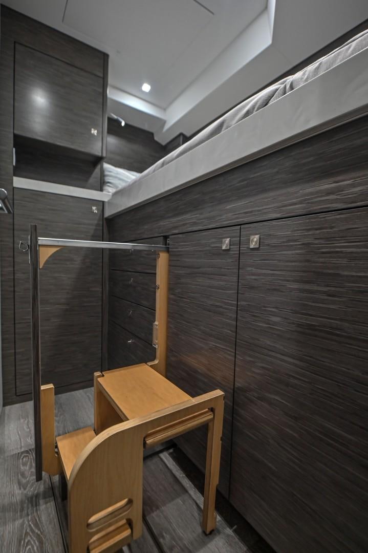 a wooden staircase with a wooden railing aboard Fish Tank Yacht for Sale