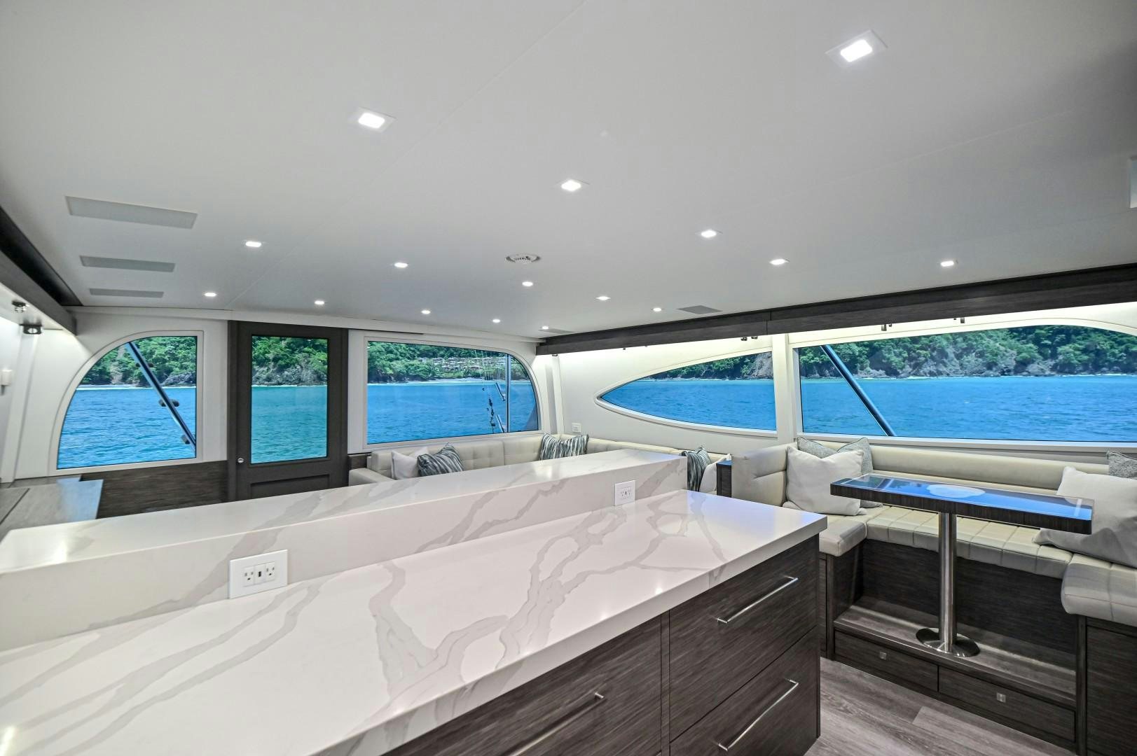 a room with a bed and a window aboard Fish Tank Yacht for Sale
