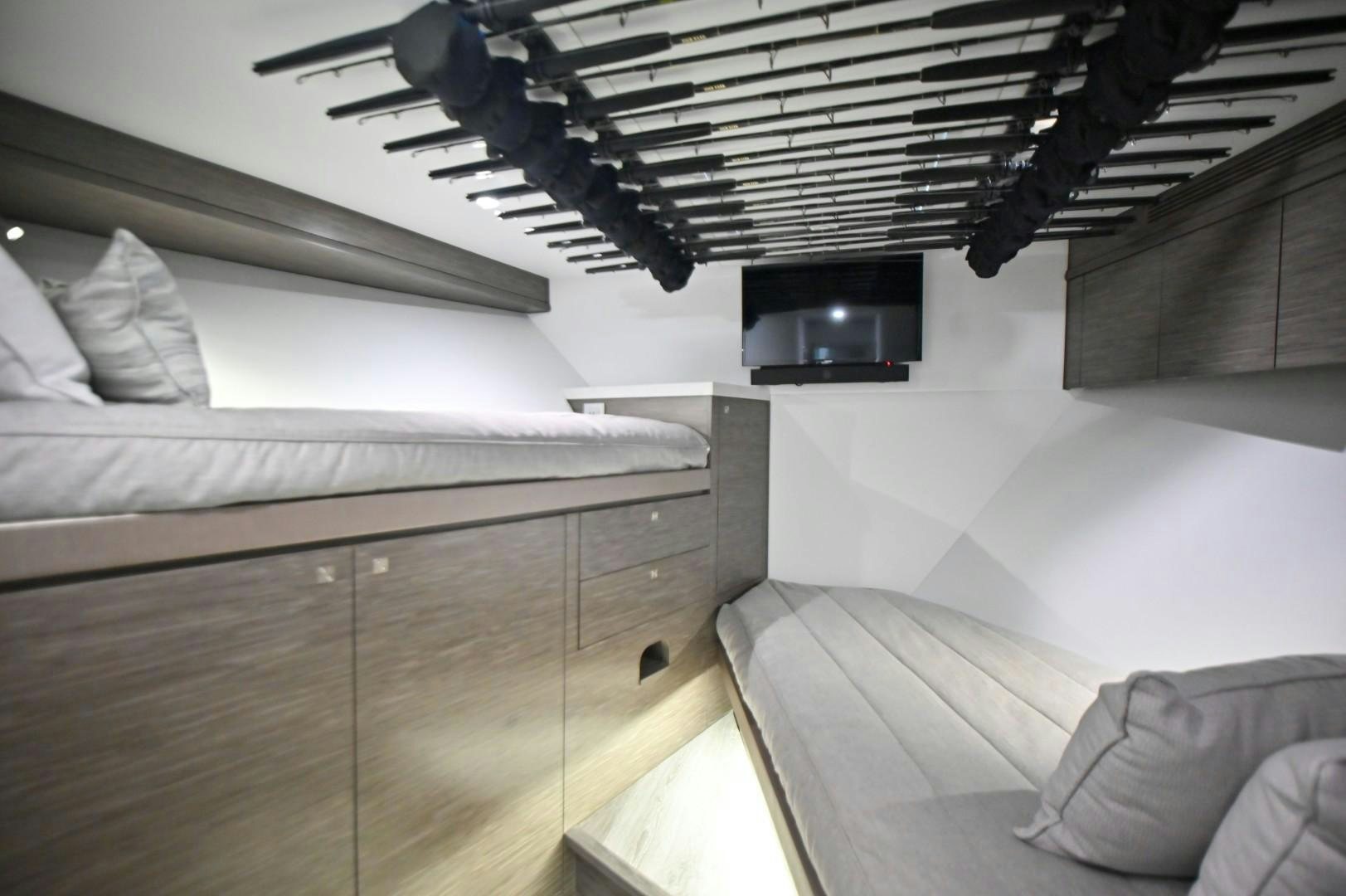 a bedroom with a bed and a television aboard Fish Tank Yacht for Sale