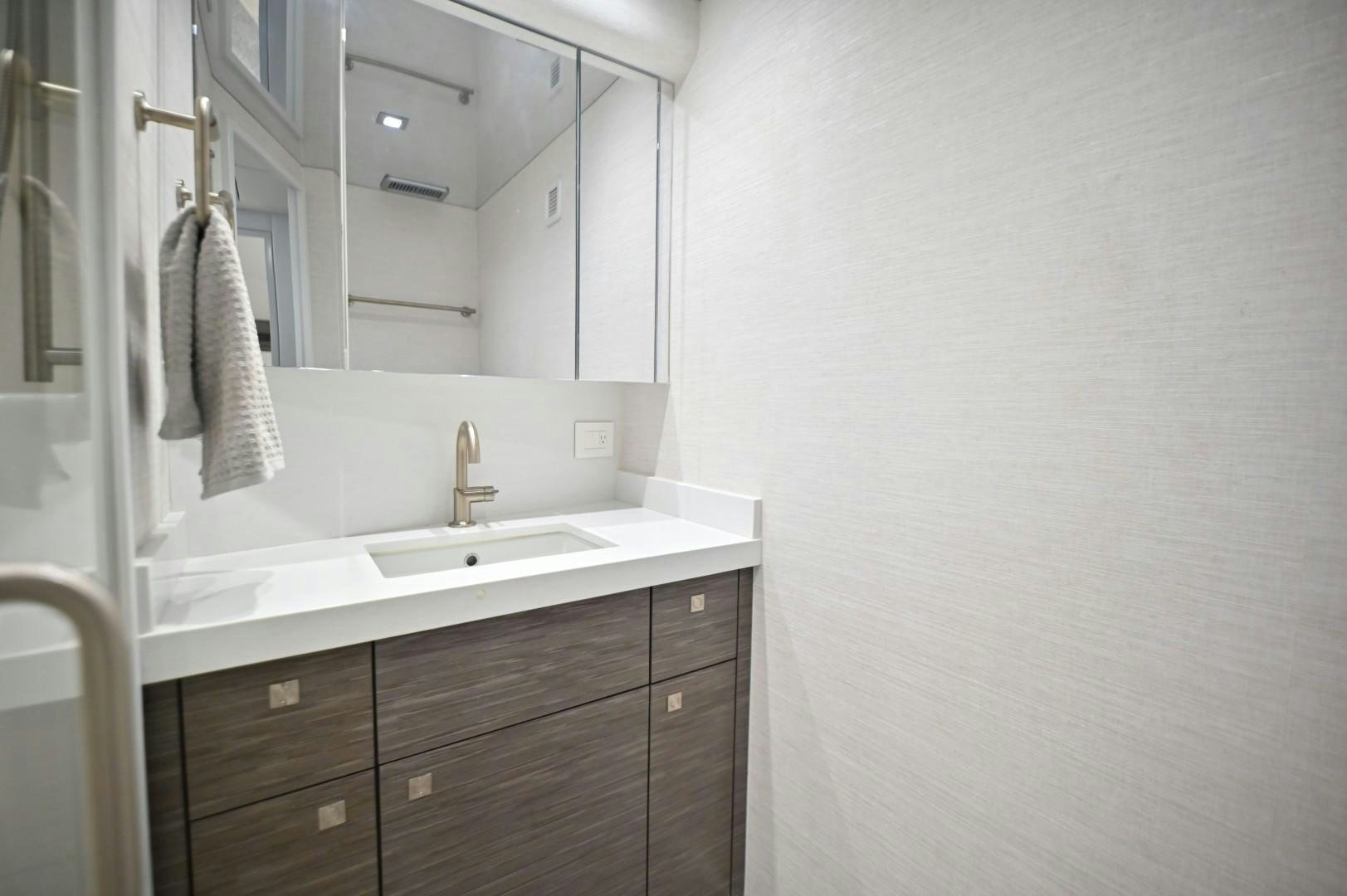 a bathroom with a sink and a mirror aboard Fish Tank Yacht for Sale