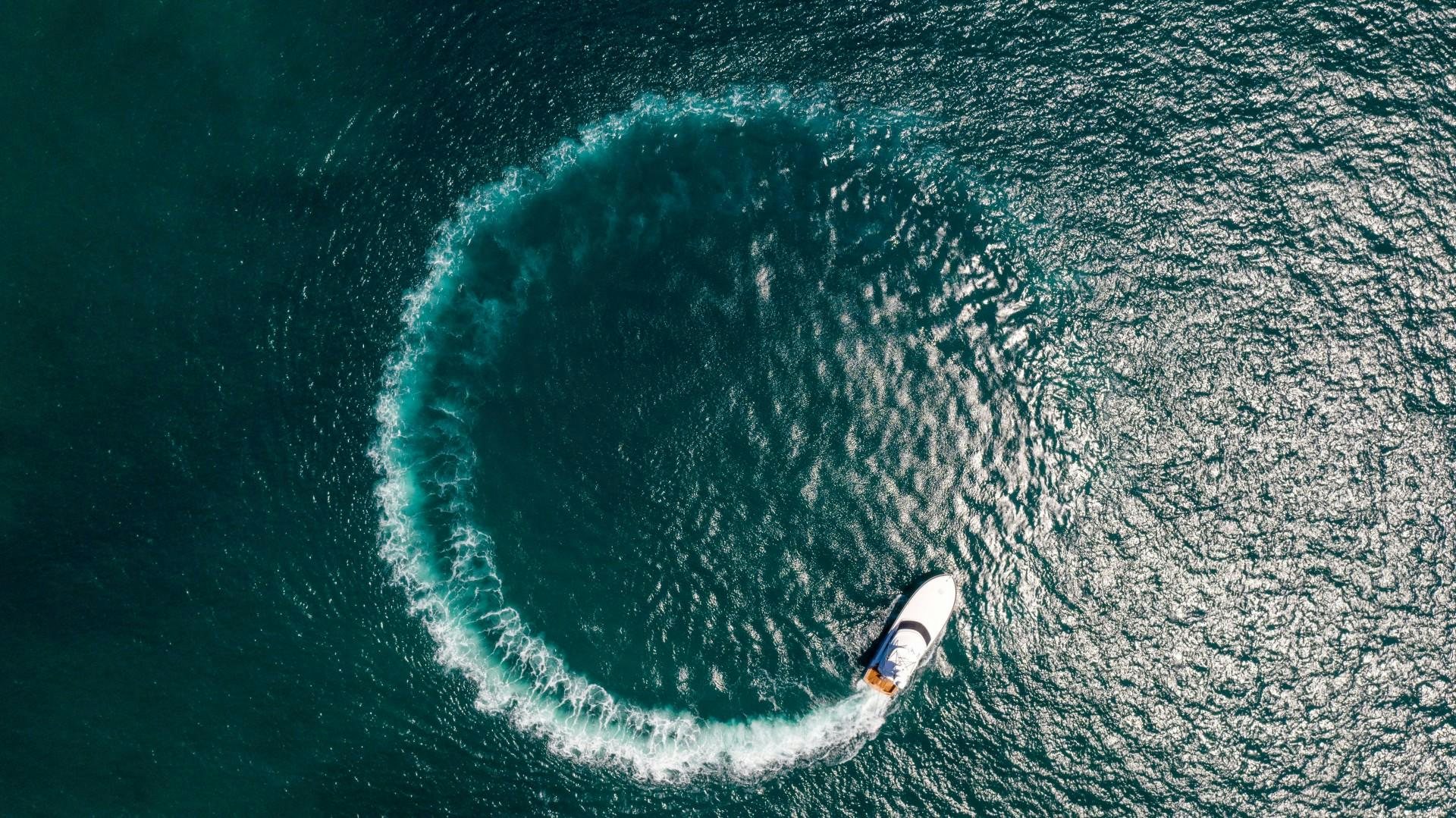 a surfer riding a wave aboard Fish Tank Yacht for Sale