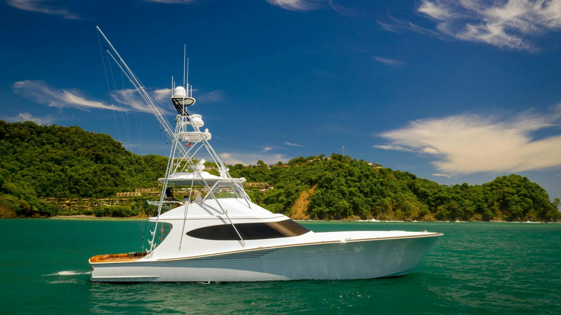 a white boat in the water aboard Fish Tank Yacht for Sale