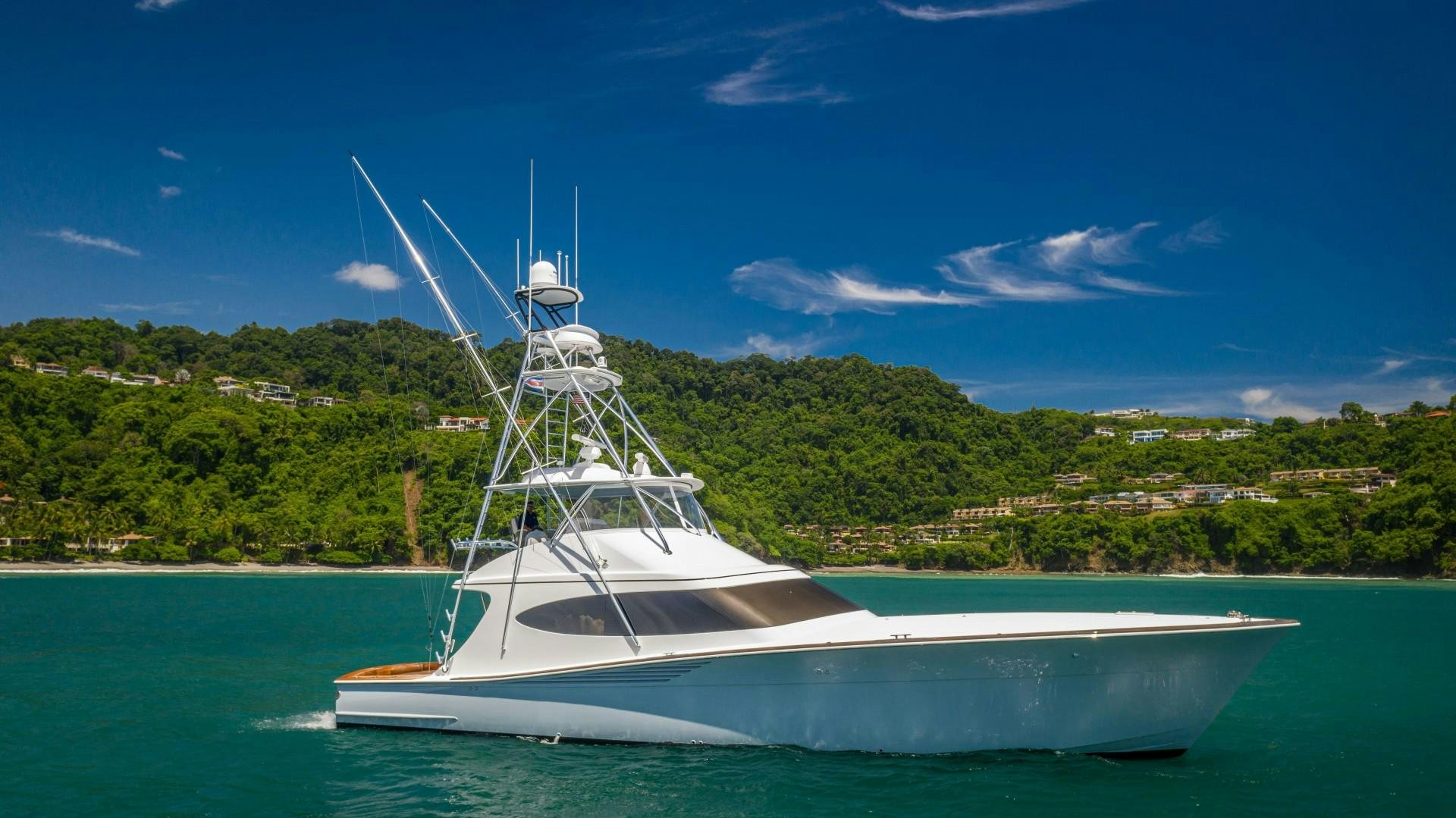 a white boat on the water aboard Fish Tank Yacht for Sale