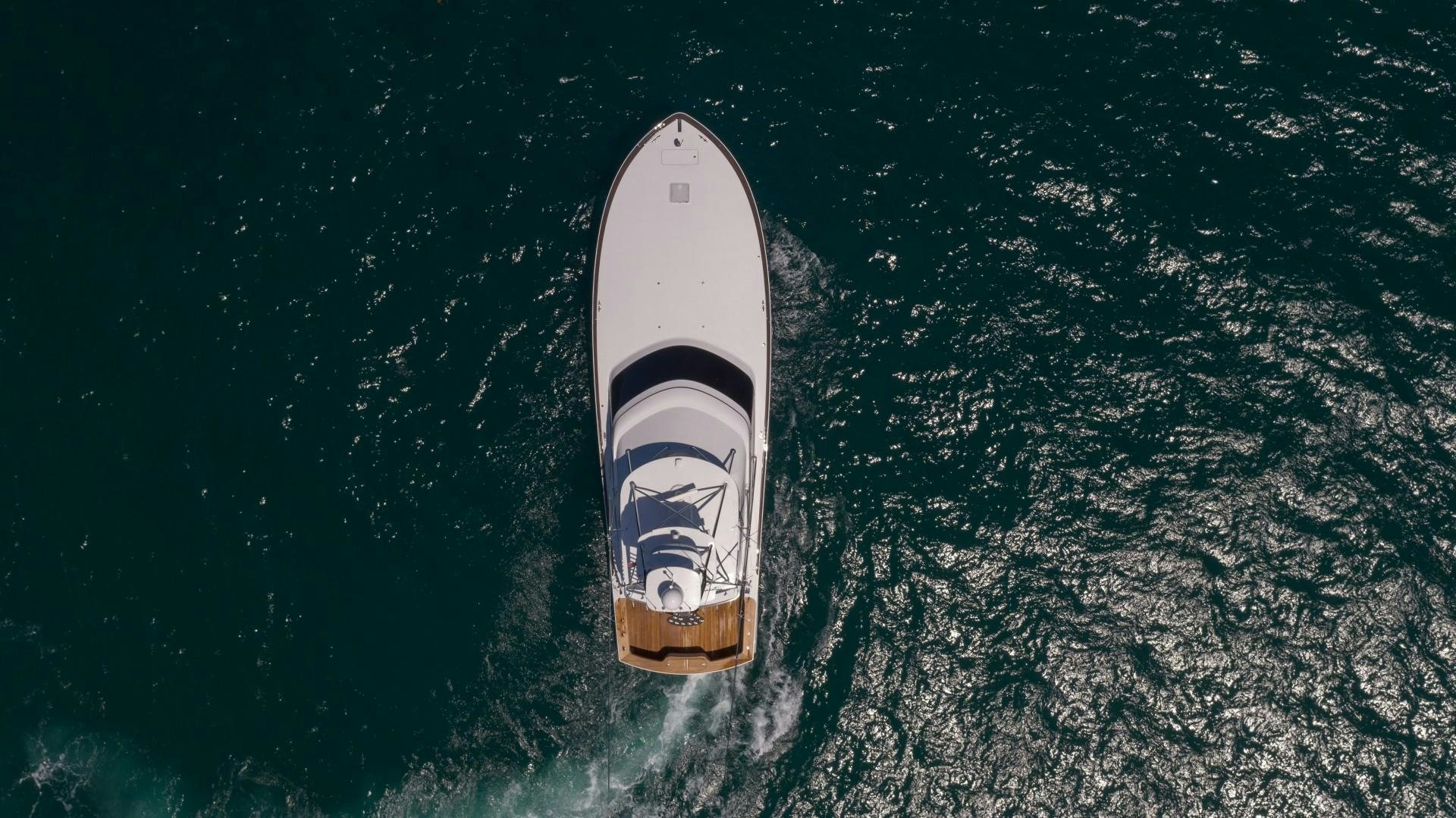 a white rocket floating in the water aboard Fish Tank Yacht for Sale