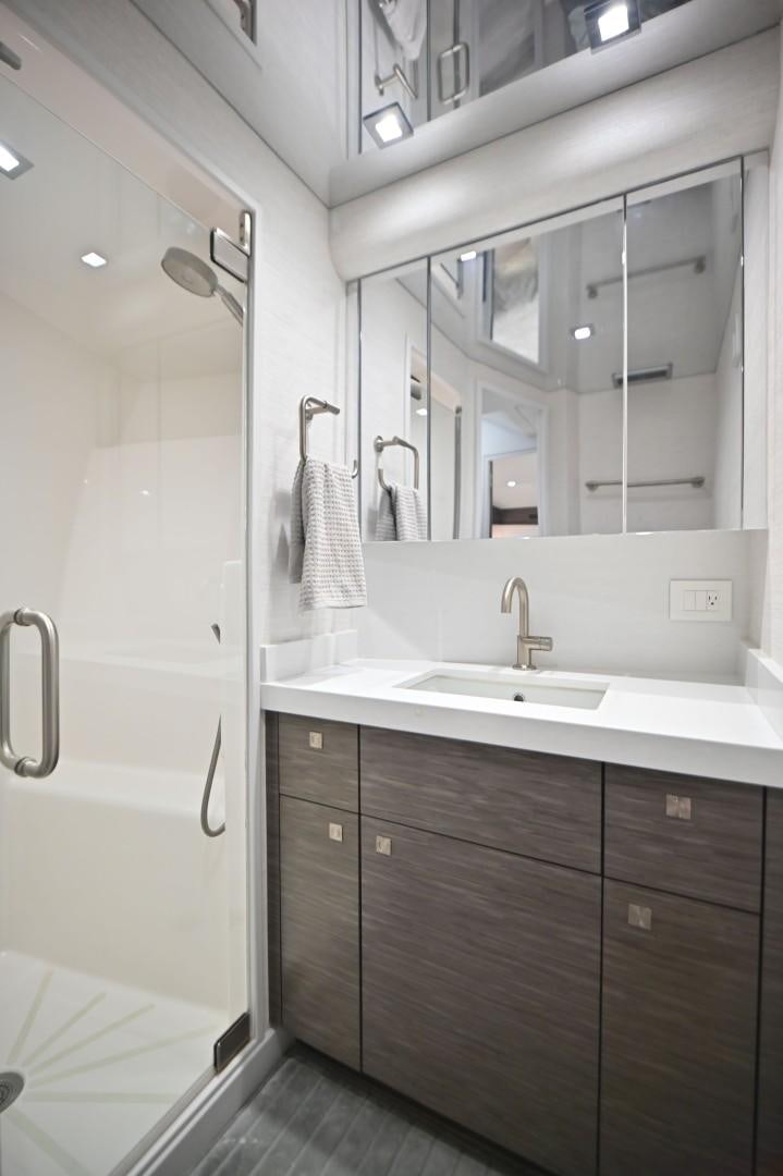 a bathroom with a sink and a mirror aboard Fish Tank Yacht for Sale