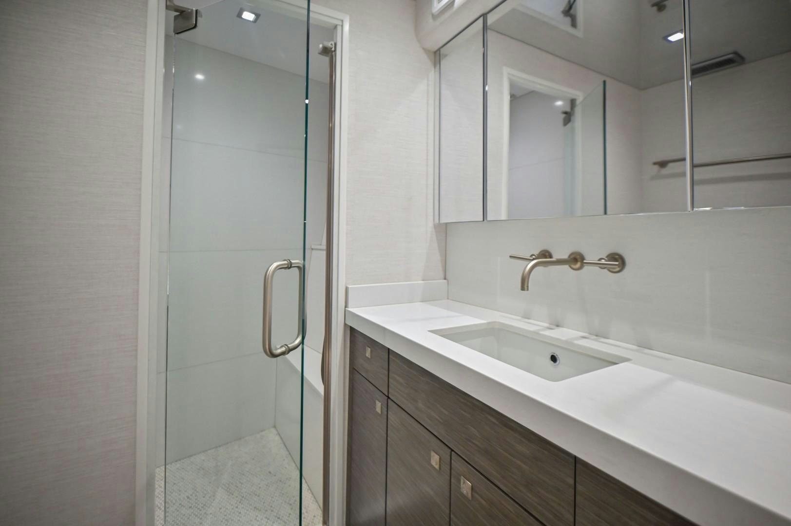 a bathroom with a sink and a mirror aboard Fish Tank Yacht for Sale