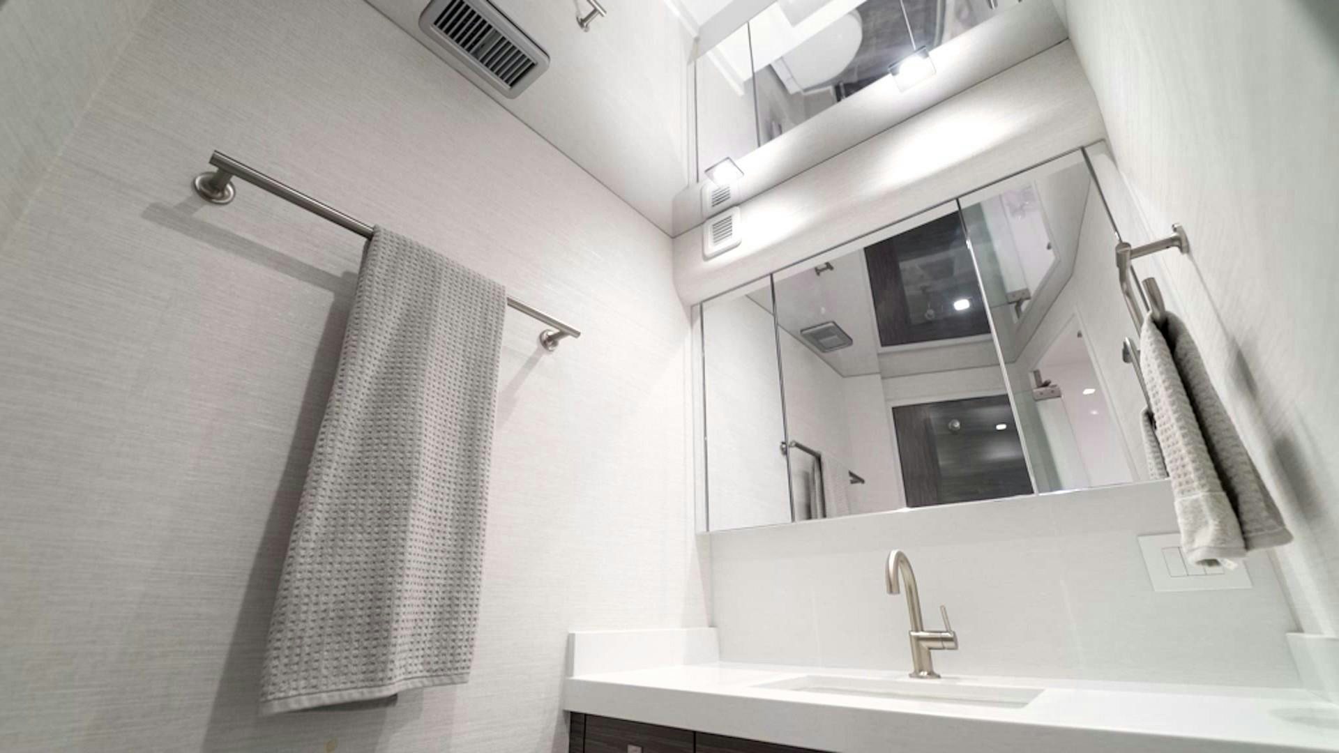 a bathroom with a sink and a mirror aboard Fish Tank Yacht for Sale