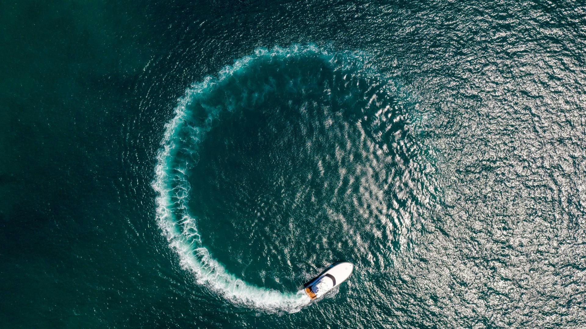 a surfer riding a wave aboard Fish Tank Yacht for Sale