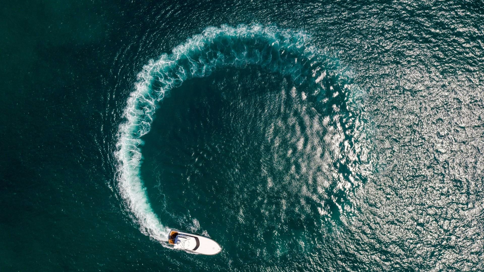 a surfer riding a wave aboard Fish Tank Yacht for Sale