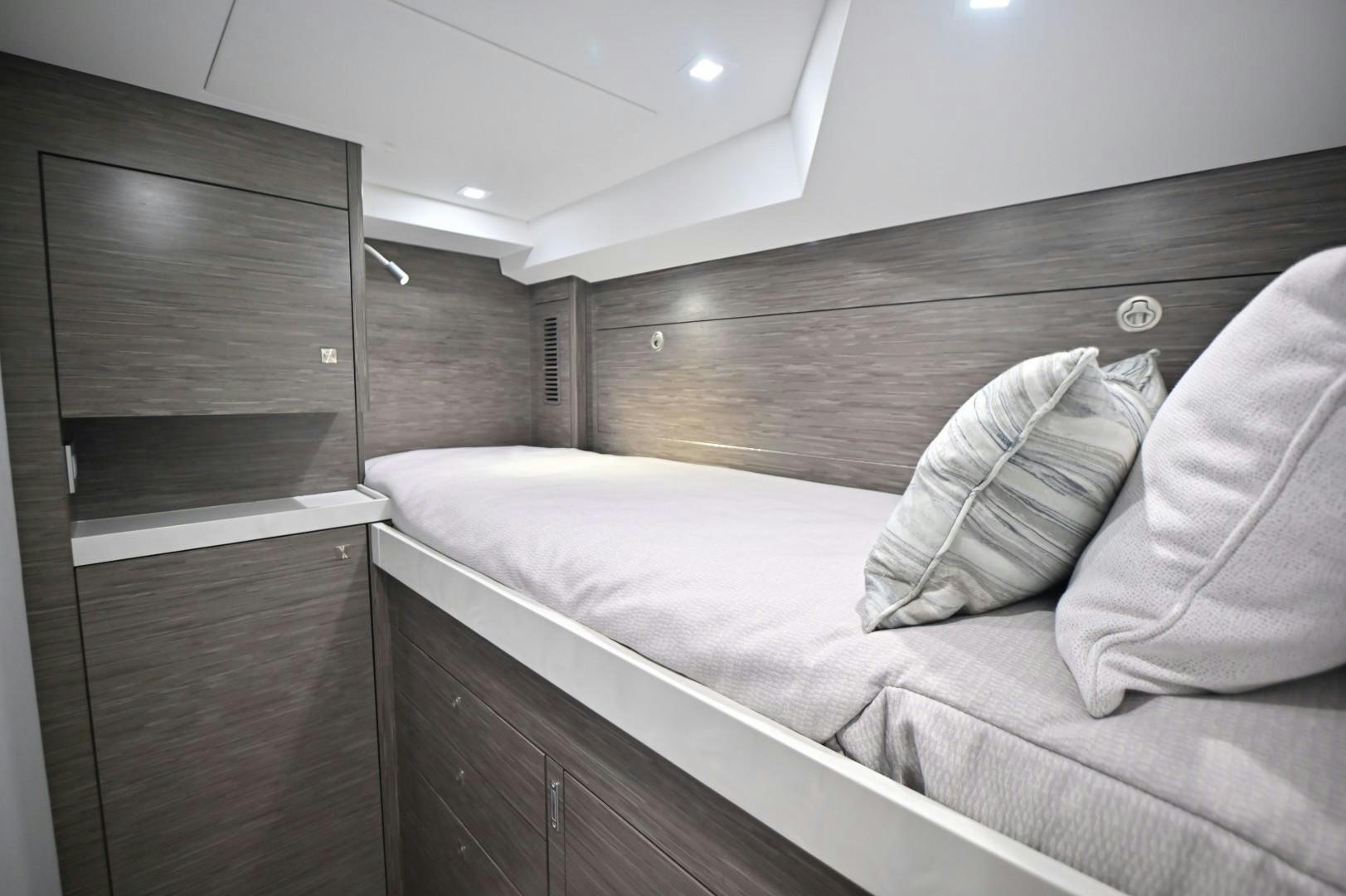 a bed in a room aboard Fish Tank Yacht for Sale