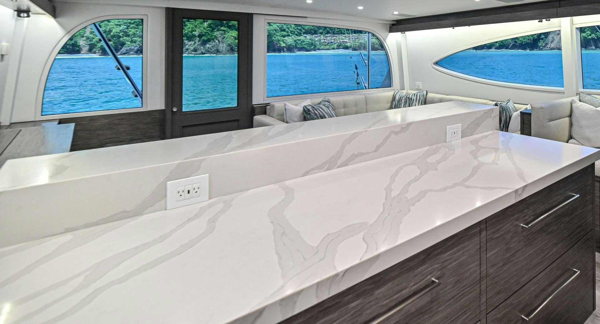 a large white bed in a room aboard Fish Tank Yacht for Sale