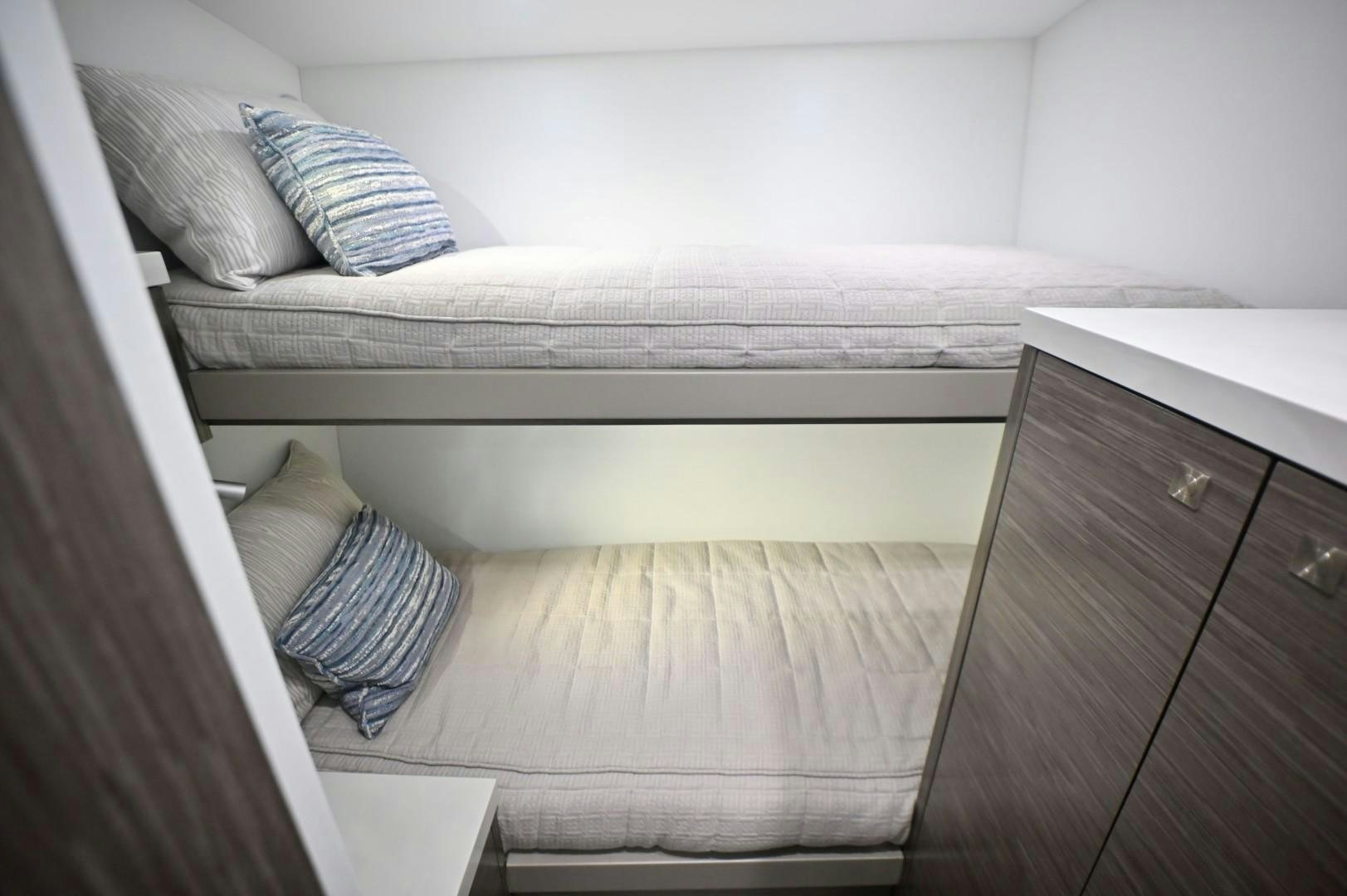 a bed with white sheets aboard Fish Tank Yacht for Sale
