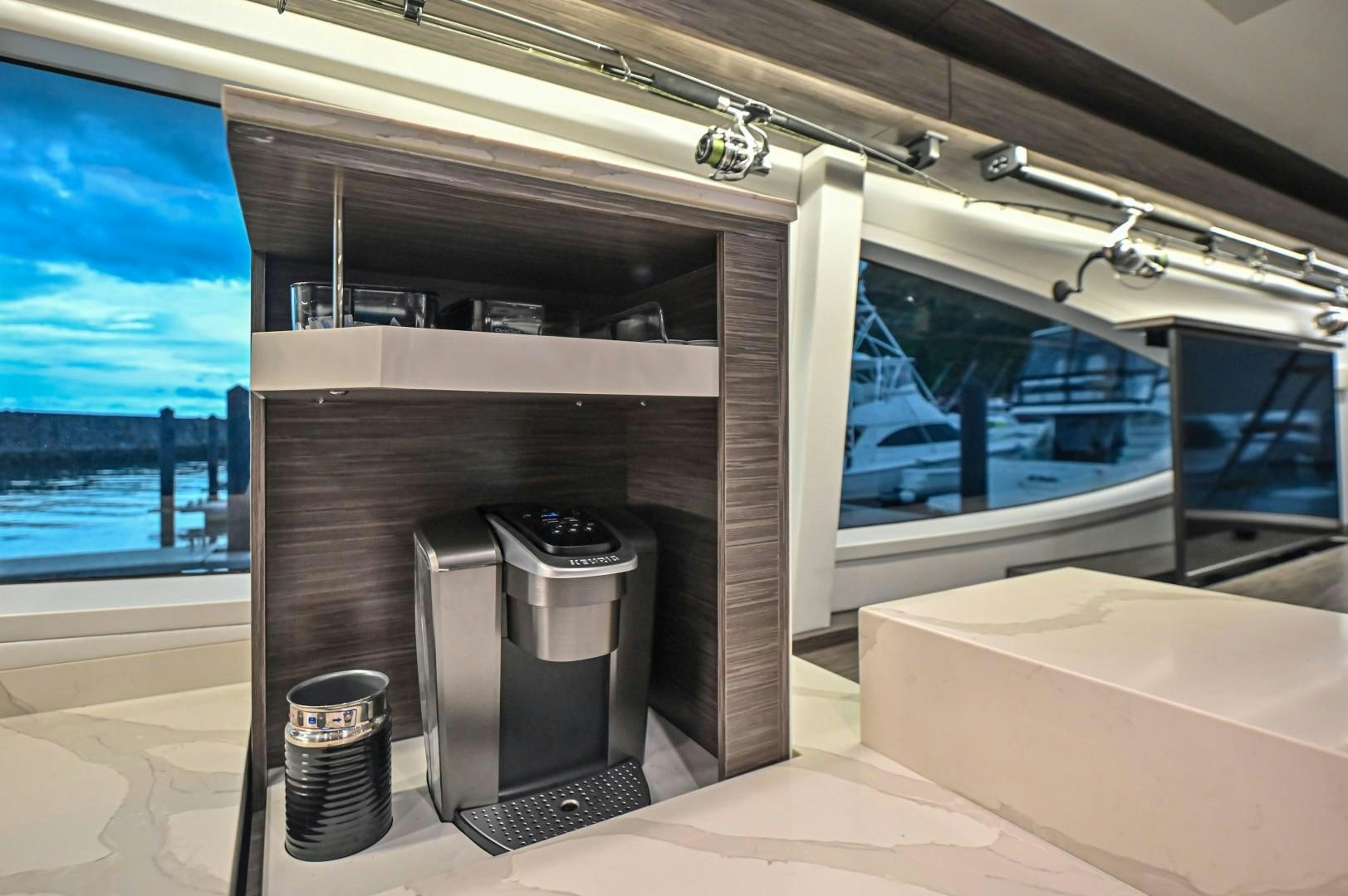 a room with a large window and a couple of trash cans aboard Fish Tank Yacht for Sale