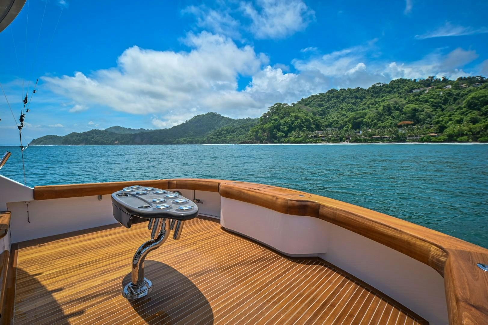a table on a deck overlooking a body of water aboard Fish Tank Yacht for Sale
