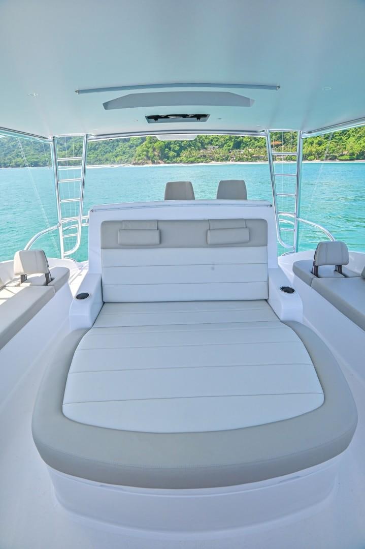 a white bed on a boat aboard Fish Tank Yacht for Sale