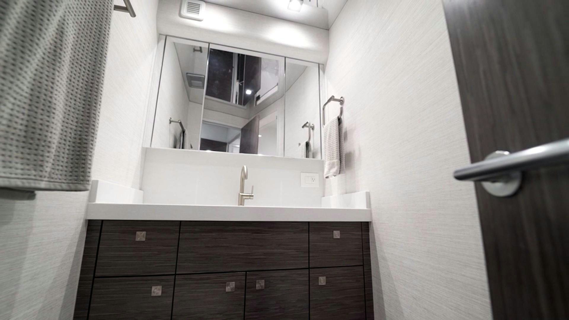 a bathroom with a sink and cabinets aboard Fish Tank Yacht for Sale
