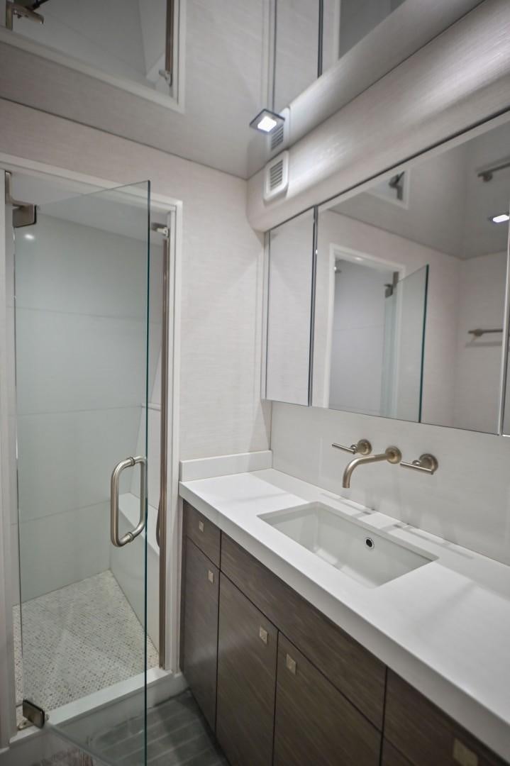 a bathroom with a glass shower door aboard Fish Tank Yacht for Sale
