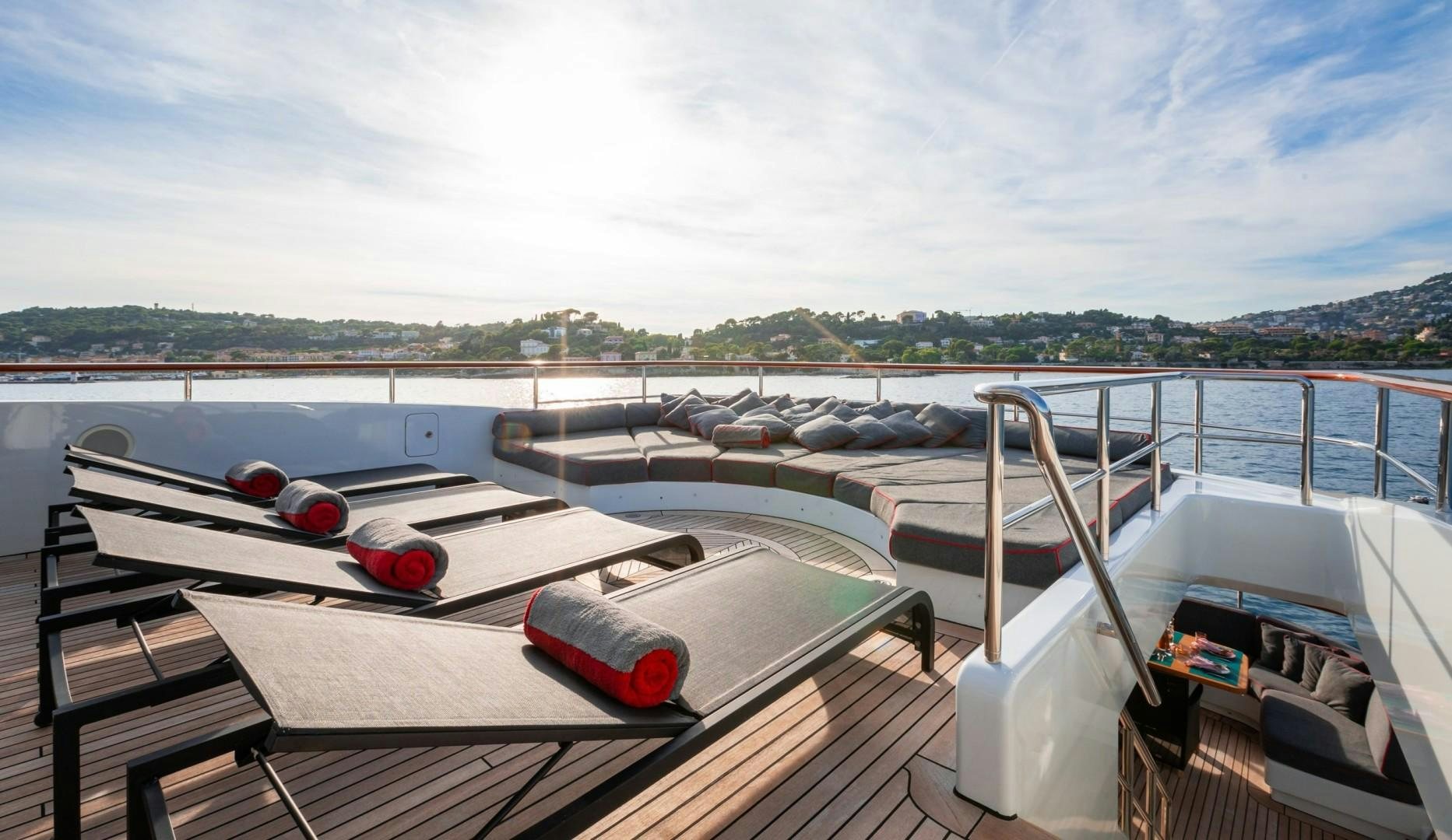 a deck with a boat and a book on it aboard LIBERTY Yacht for Sale