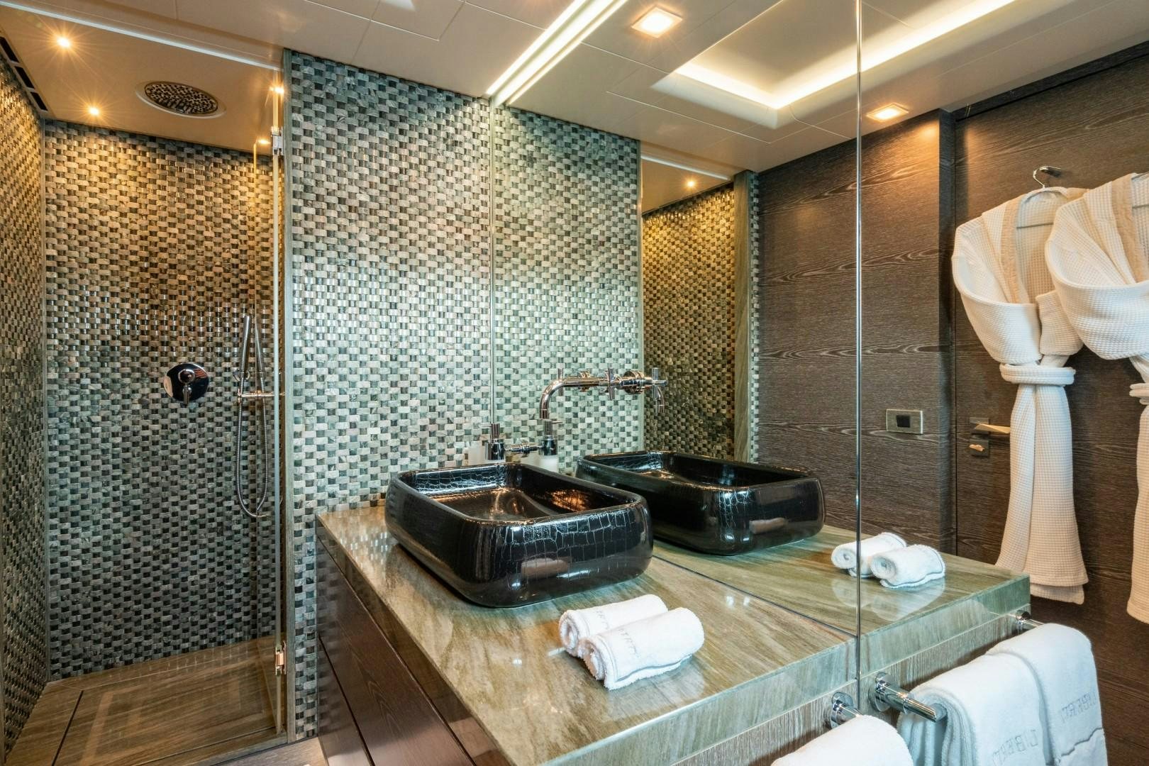 a bathroom with a sink and a large mirror aboard LIBERTY Yacht for Sale