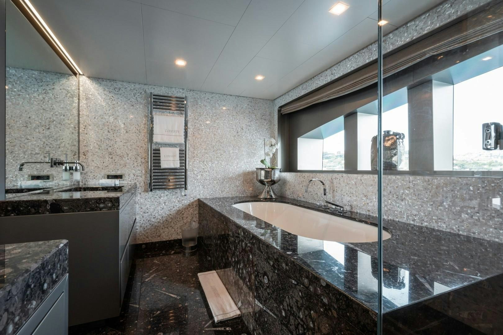 a large bathroom with a large marble counter top aboard LIBERTY Yacht for Sale