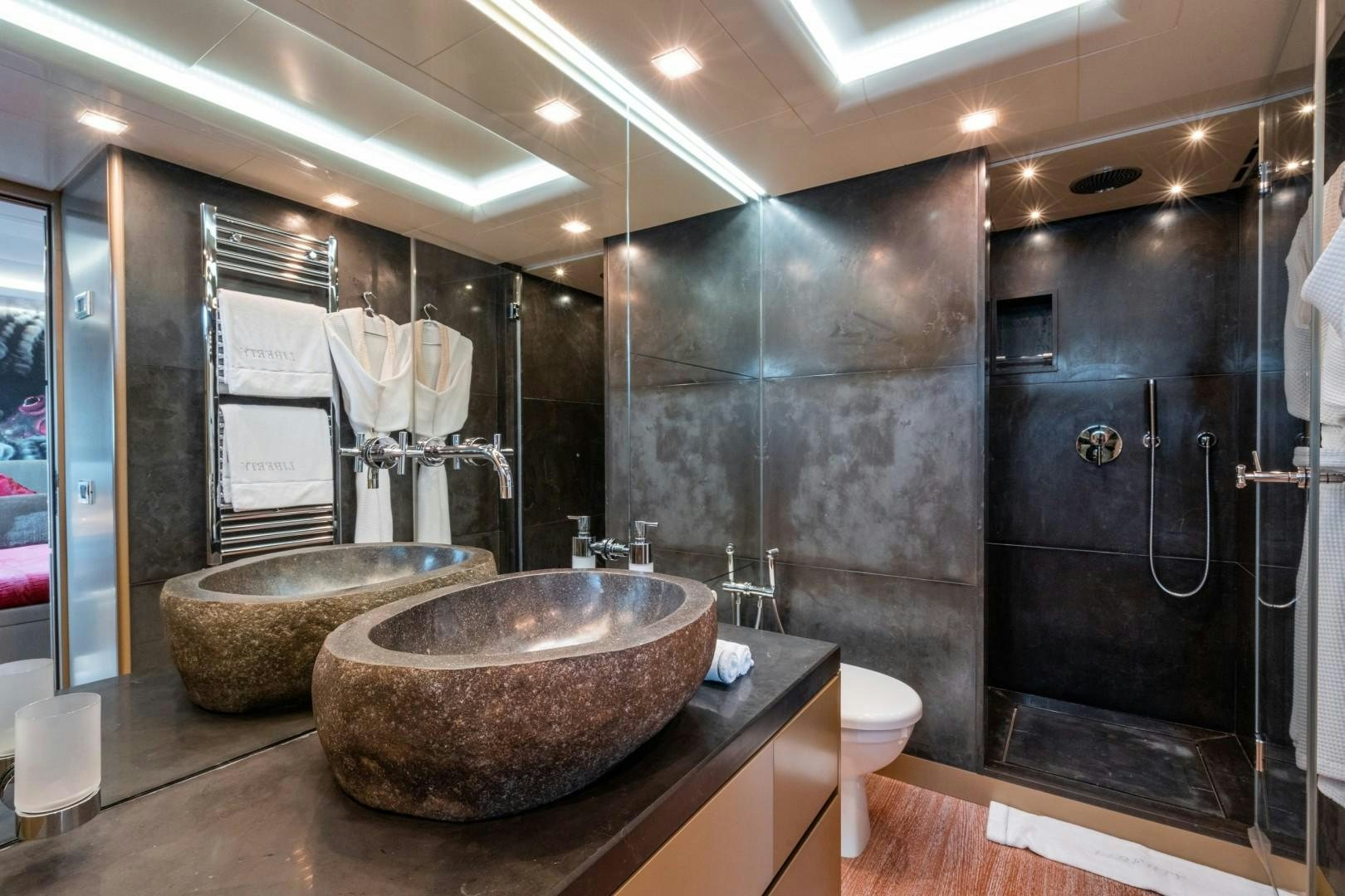 a bathroom with a large marble sink aboard LIBERTY Yacht for Sale