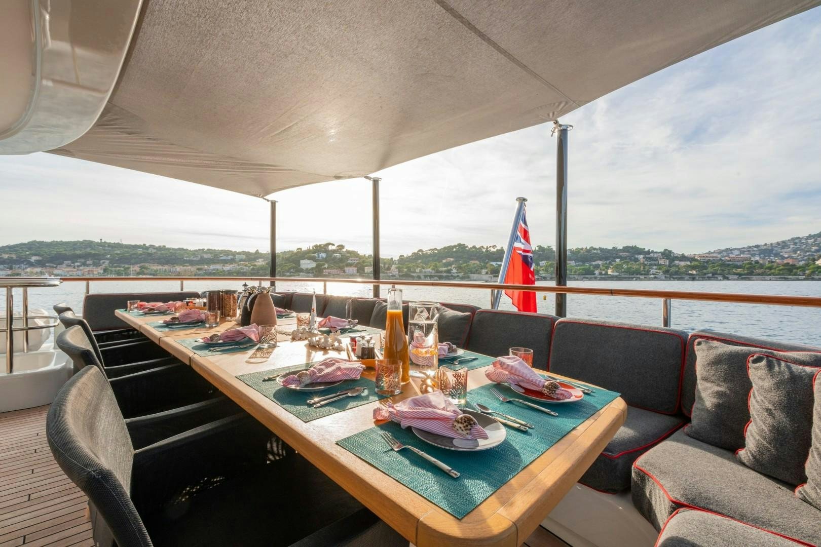 a table with plates and glasses on it aboard LIBERTY Yacht for Sale